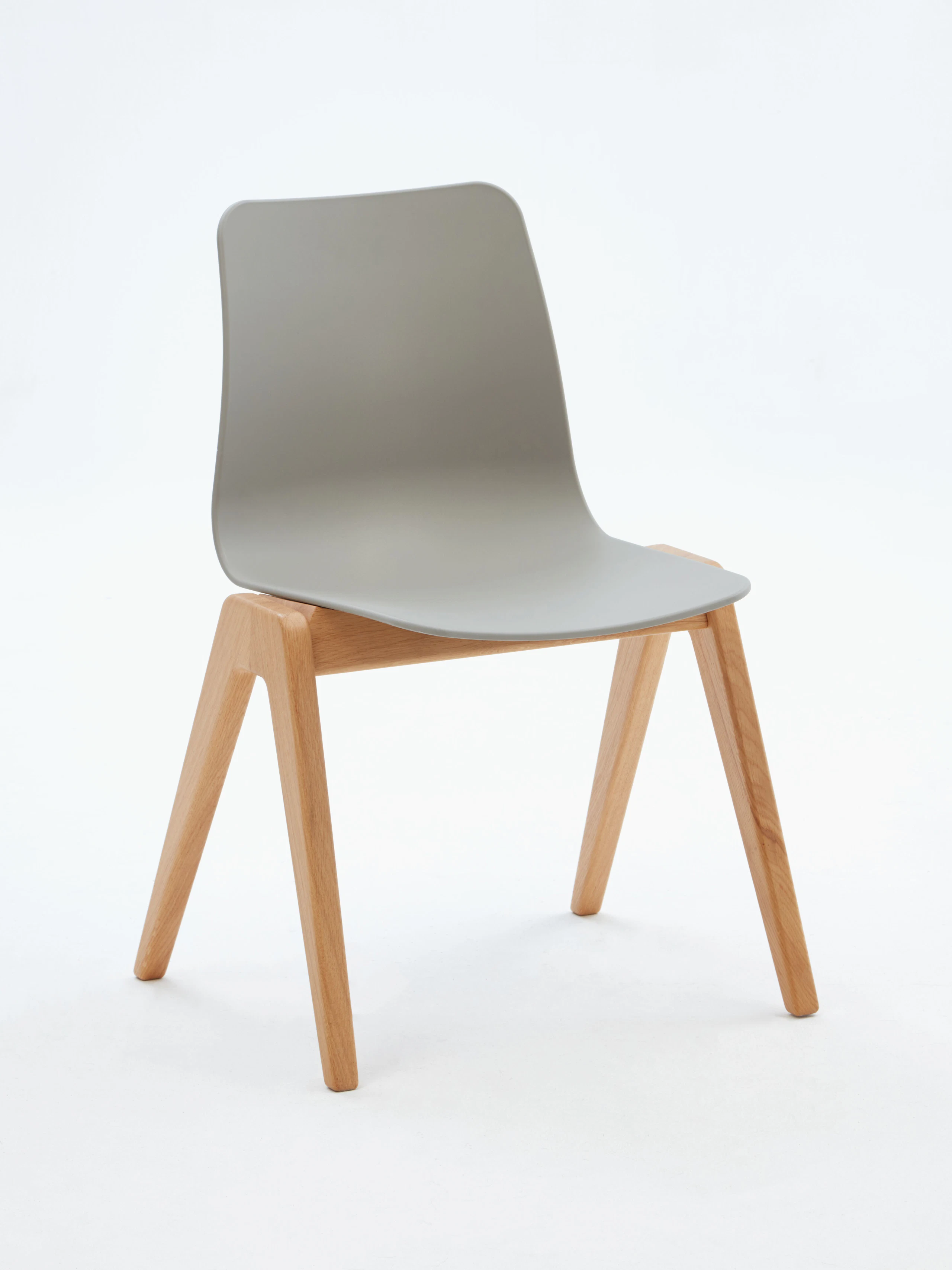 A gray naughtone Polly Wood Chair with an oak base, viewed at an angle.