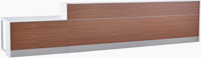 Prefab Commend Nurses Station for three with white Corian tops, walnut woodgrain laminate front and stainless steel toe kicks.