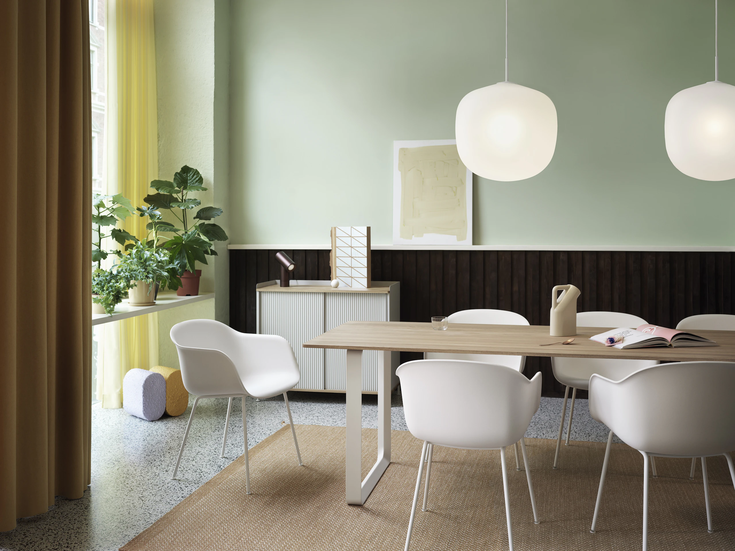 White Fiber Armchairs by Muuto surrounding a 70/70 dining table by Muuto. 