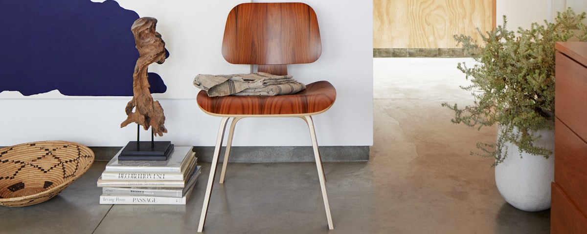 Eames Molded Plywood Dining Chair Wood Base in a home entryway setting