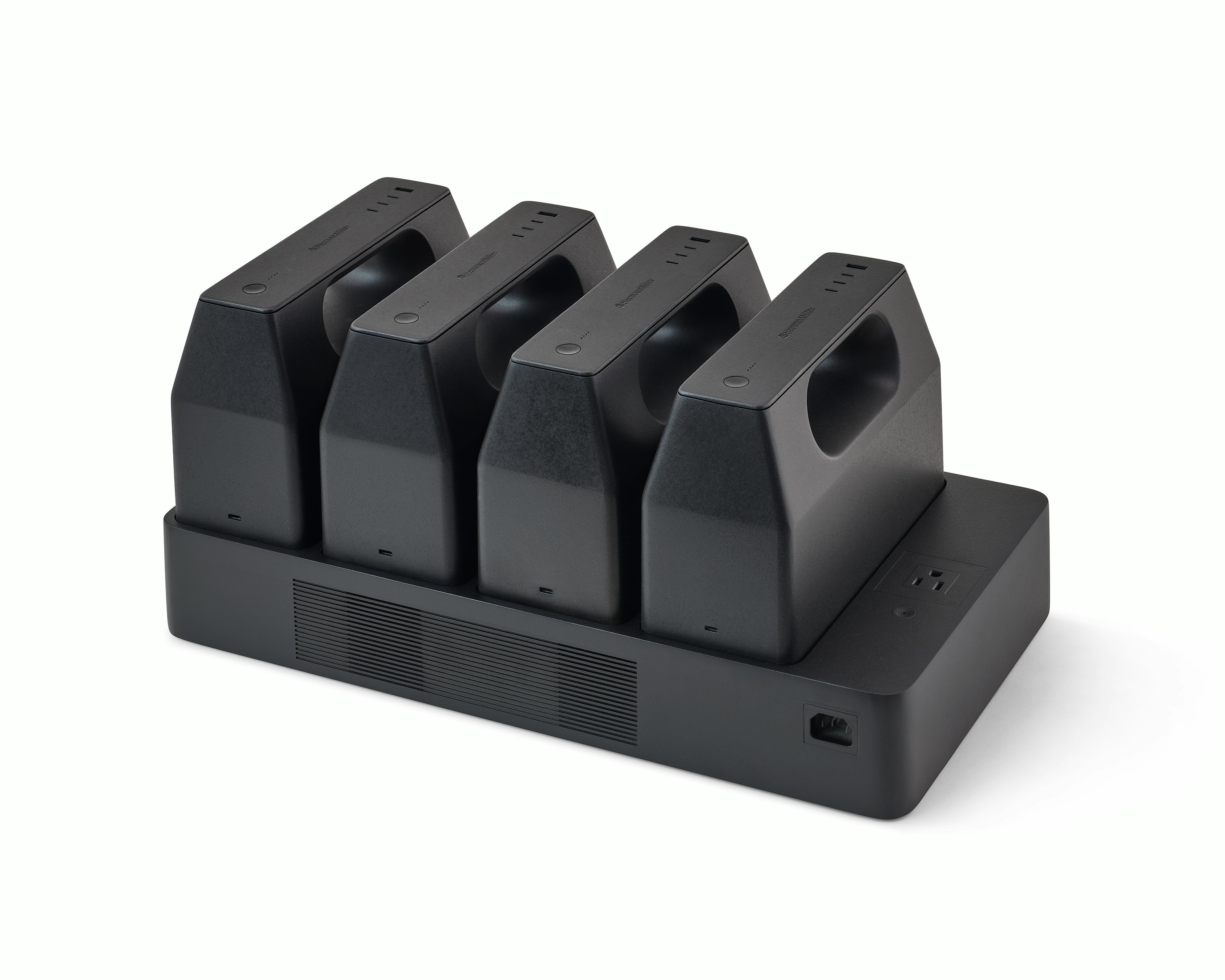 Four black OE1 Powerbox batteries mounted on a black OE1 Power Tray, viewed from an angle.