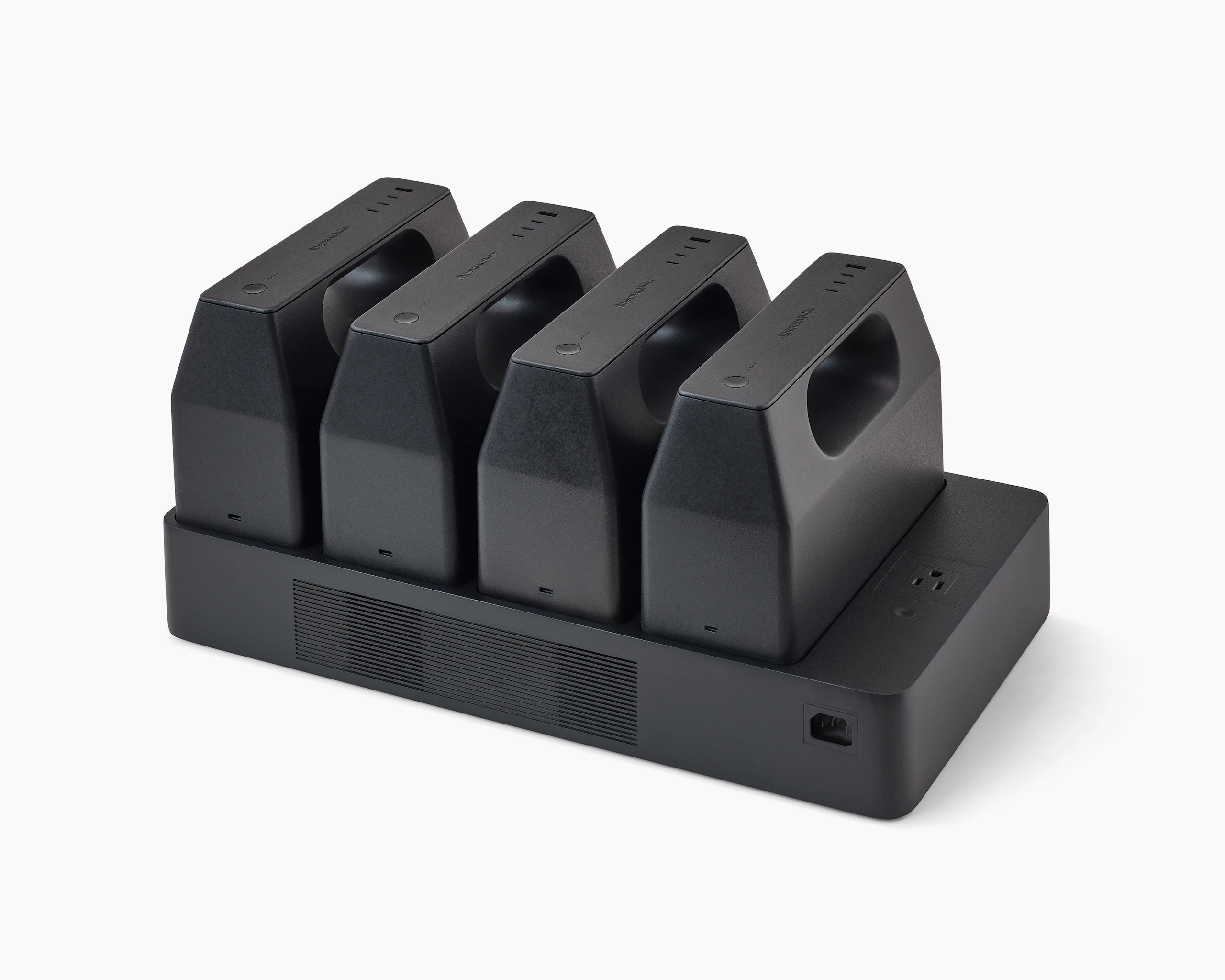 Four black OE1 Powerbox batteries mounted on a black OE1 Power Tray, viewed from an angle.