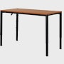 Angle view of a four leg height-adjustable table shown at standing height with a dark woodgrain surface and black base.