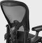 Matte black Aeron Chair on a white background, view of the back of the chair.