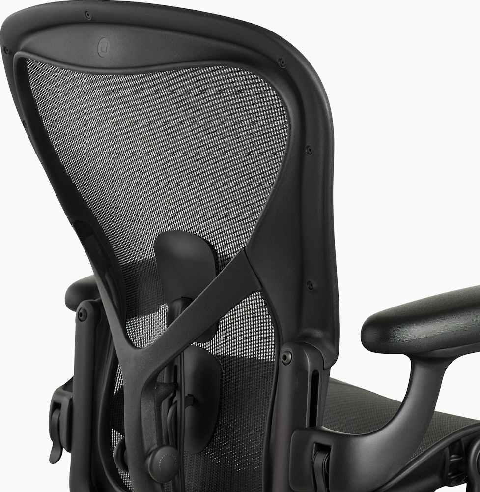 Matte black Aeron Chair on a white background, view of the back of the chair.