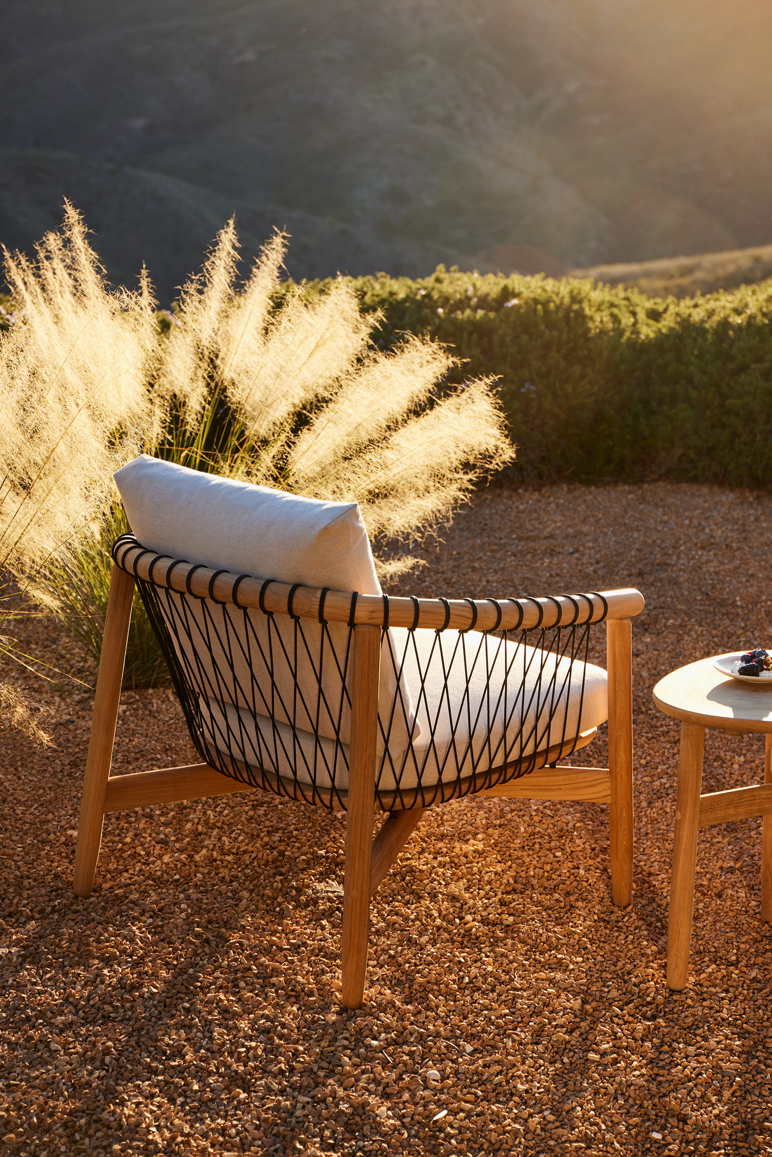 Crosshatch Outdoor Lounge Chair and Trilobe Side Table in an environmental setting.