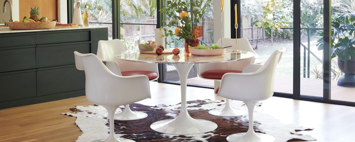 Four Saarinen Tulip Armchairs surrounding a Saarinen Dining Table in a dining room setting