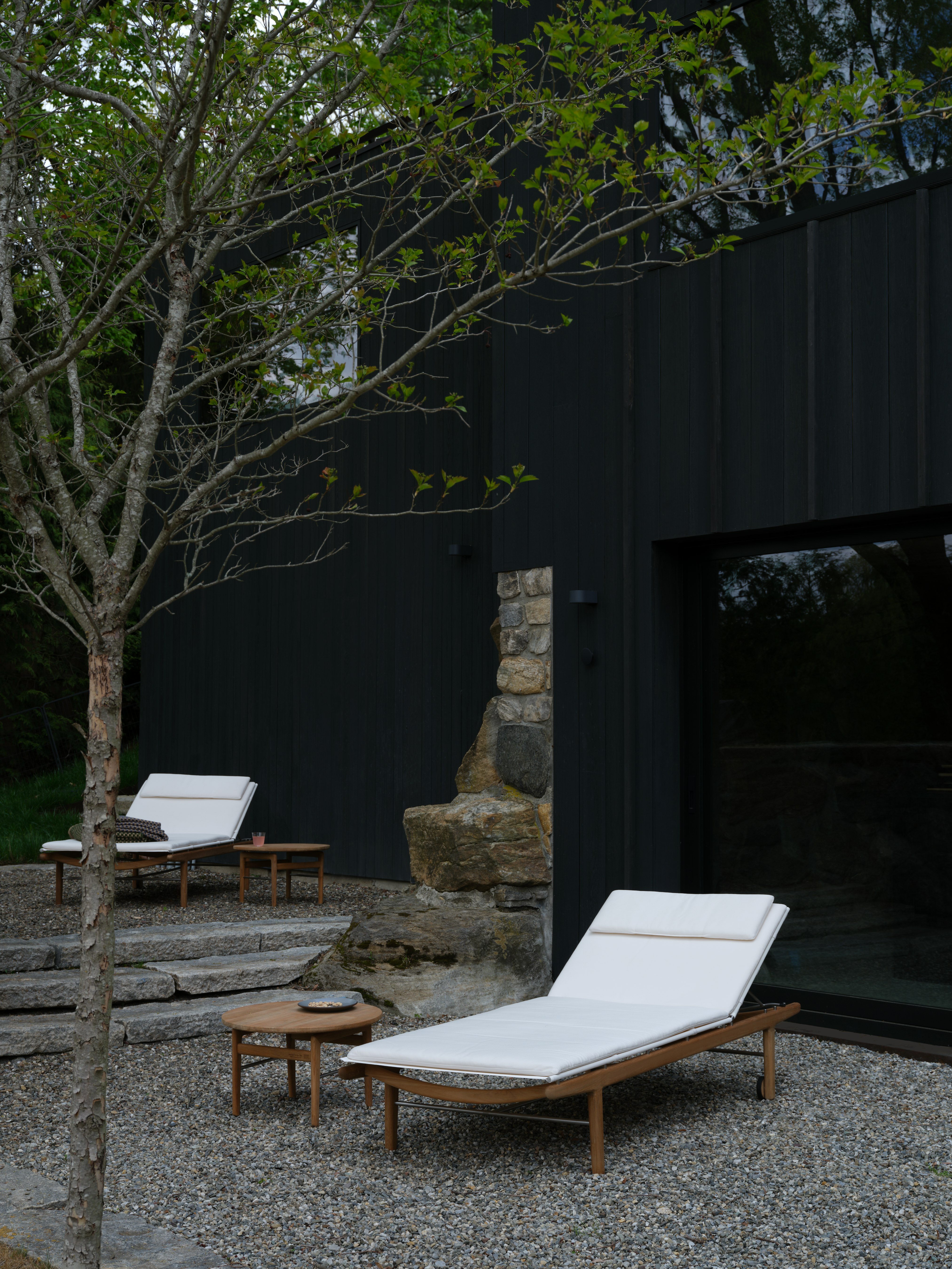 Finn Chaise Lounges in an outdoor courtyard setting