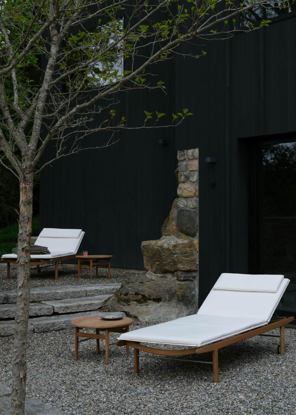 Finn Chaise Lounges in an outdoor courtyard setting
