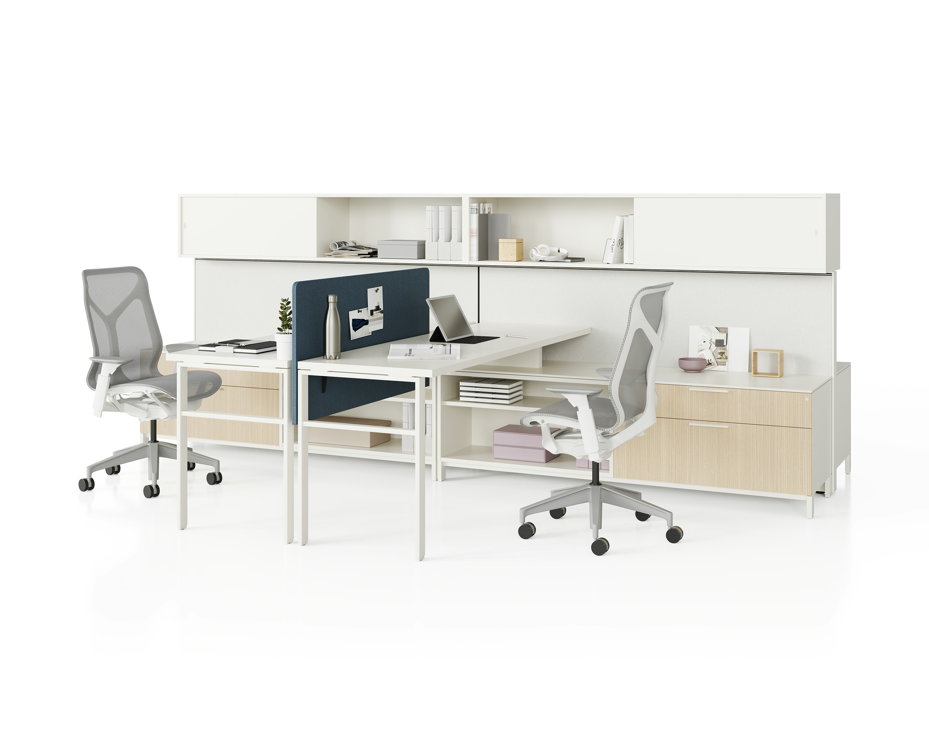 Two grey Canvas Wall workstations with wood storage, white surfaces, blue screens, and grey Cosm Chairs.