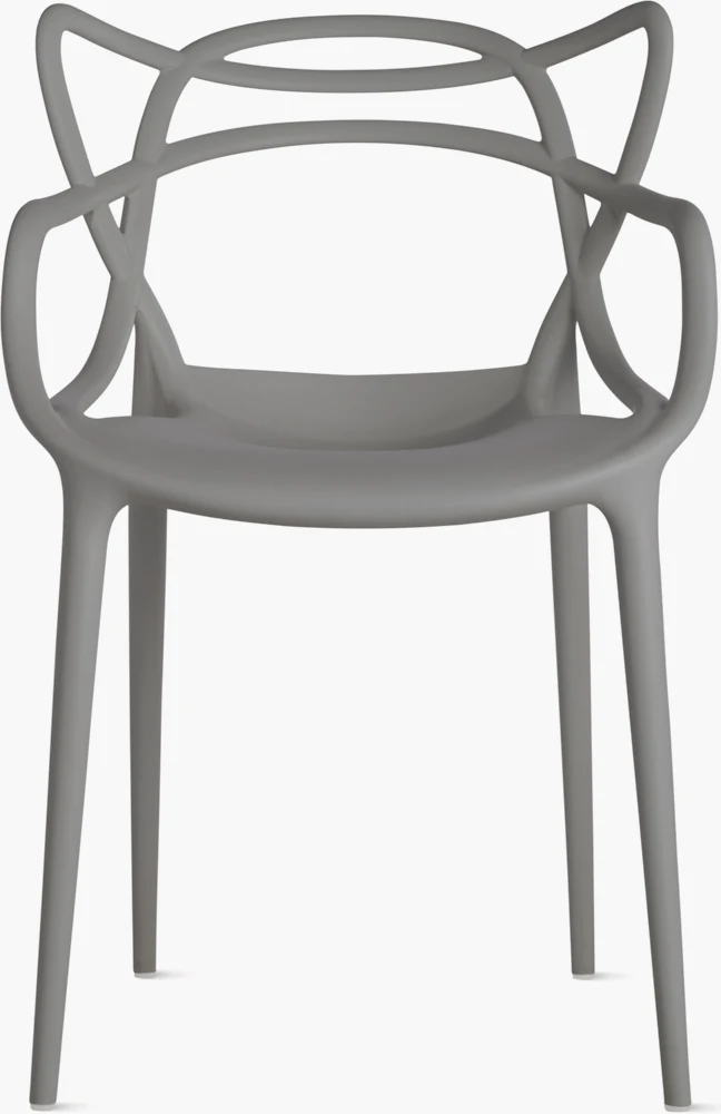 Close-up view of the legs of a white chair with slender tapered legs on a light floor.