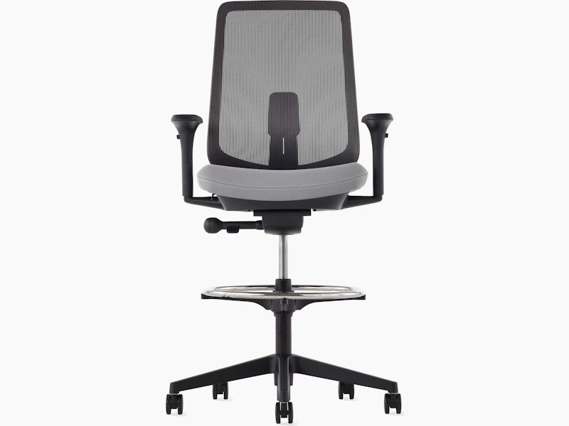 A black Verus Stool with a suspension back, grey seat and black frame viewed from the front.