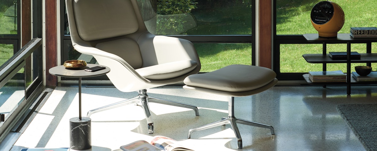 Striad Lounge Chair and Ottoman in a living room setting
