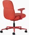 Rear angle view of a mid-back Asari chair by Herman Miller in deep red with height adjustable arms.