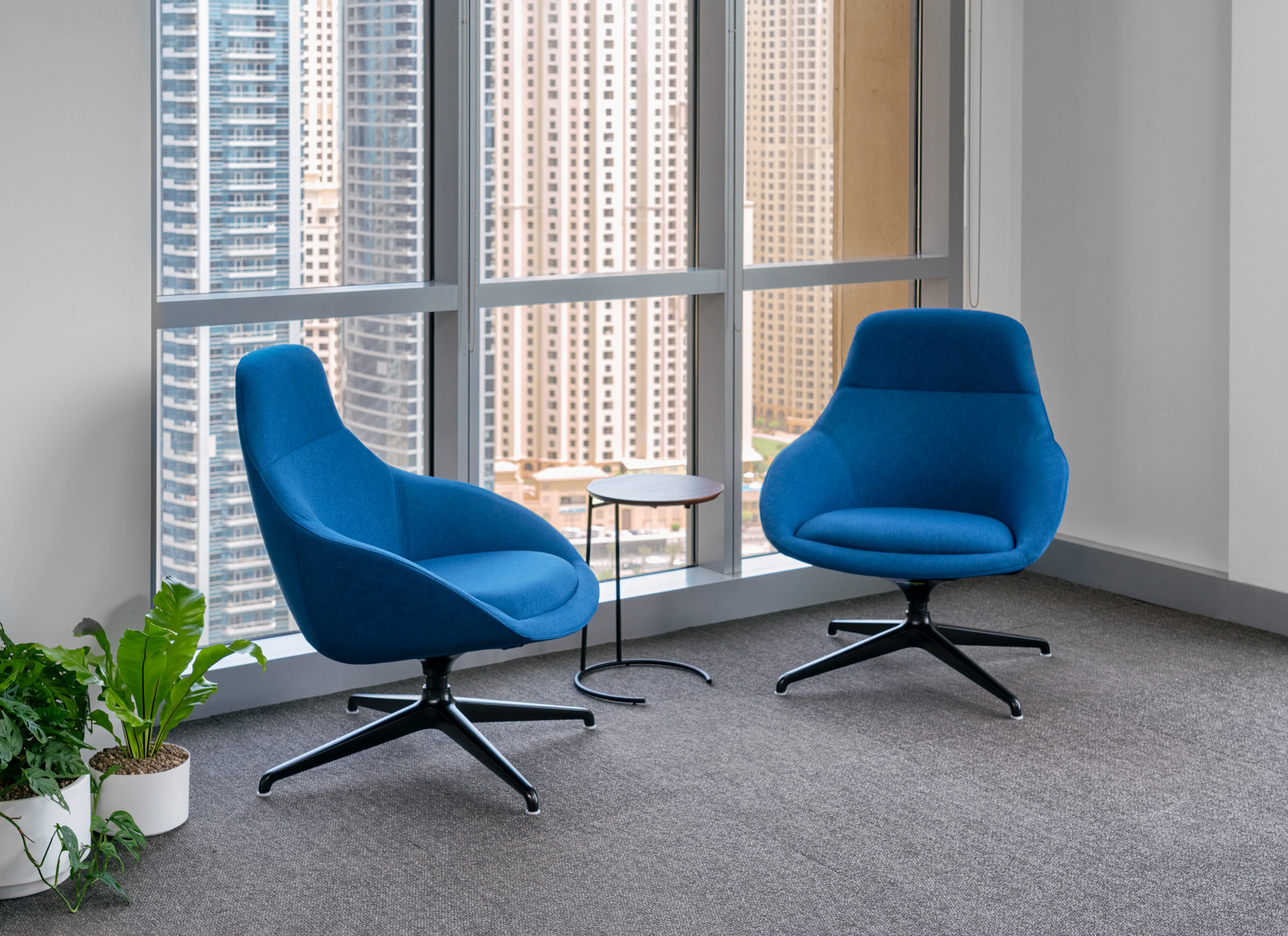 Two Always Lounge Chairs in a blue fabric with a T.710 Side Table.