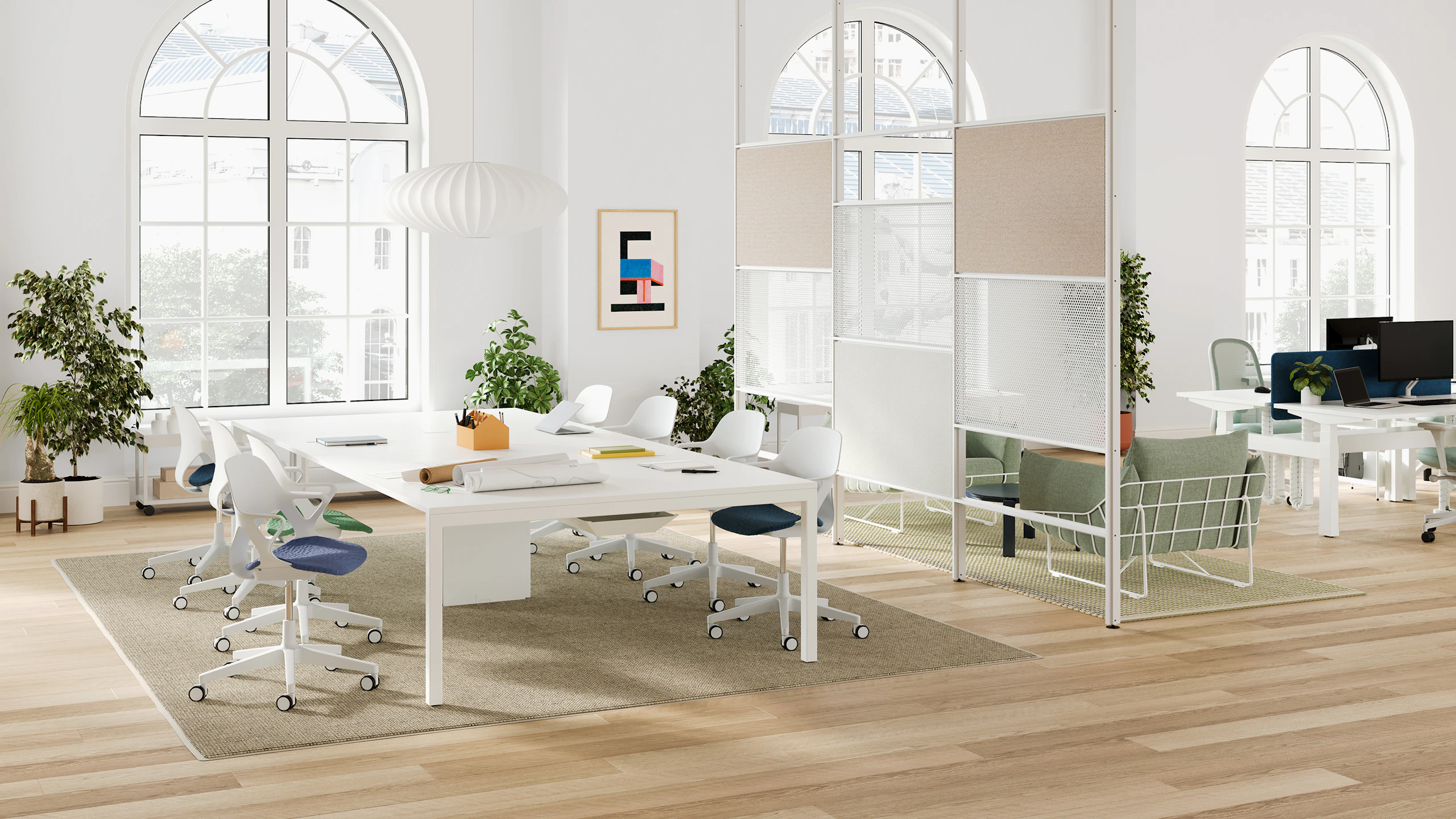 A bright collaborative office space with a Maars boundary wall and more seating in the background.
