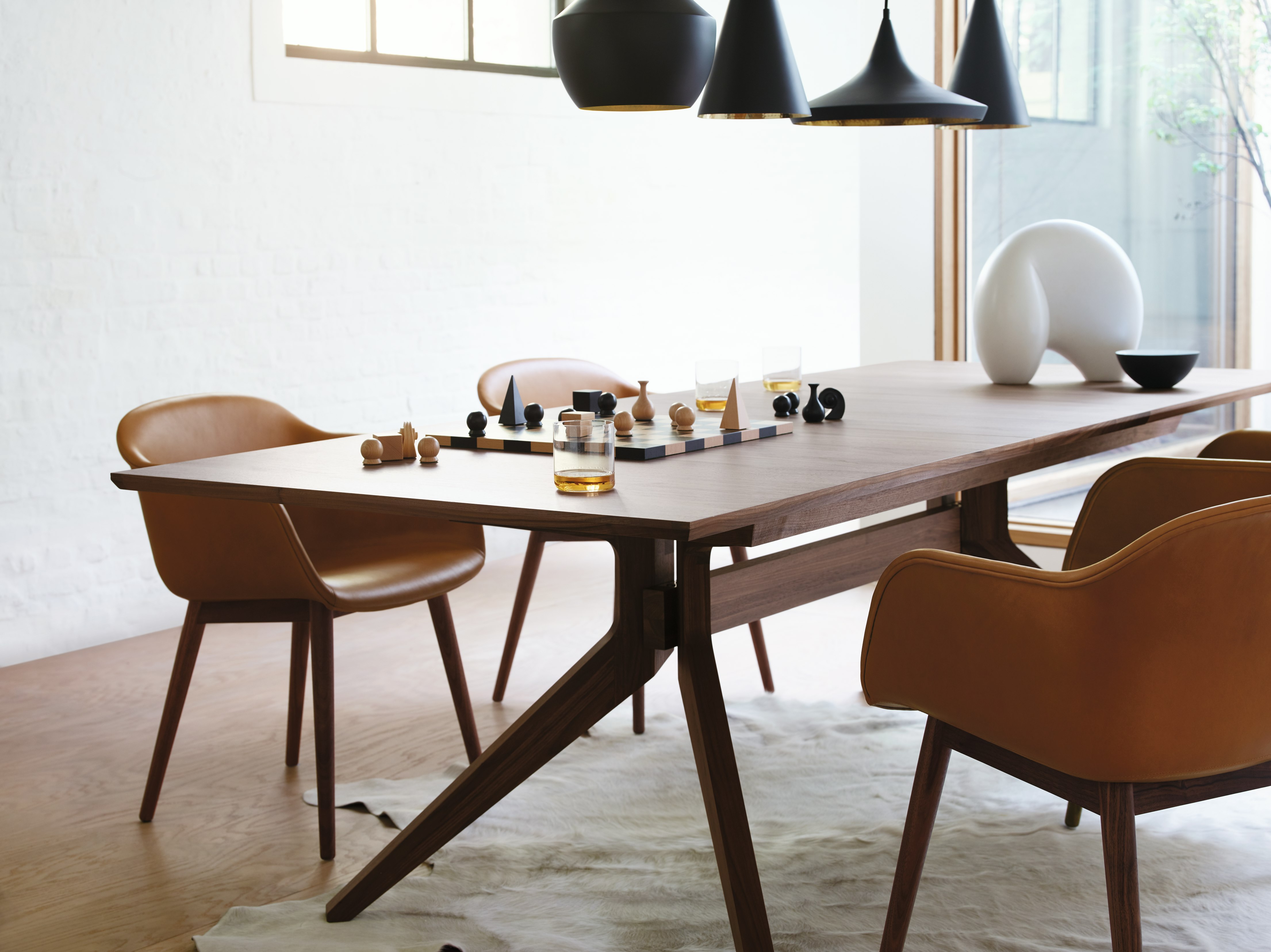 Cross Extension Table, Leather Dining Chairs, and Man Ray Chess Set