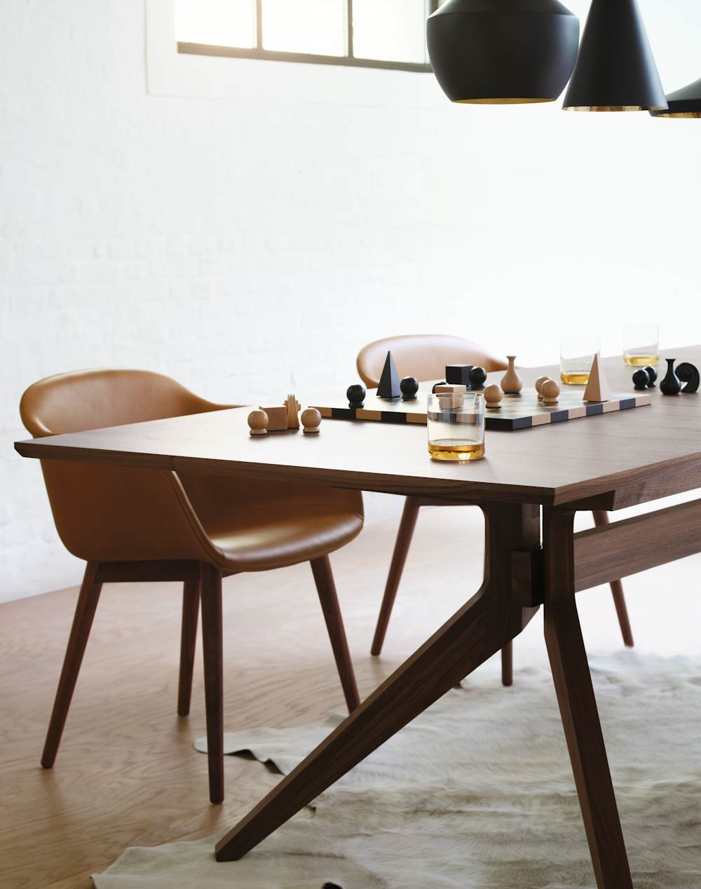 Cross Extension Table, Leather Dining Chairs, and Man Ray Chess Set