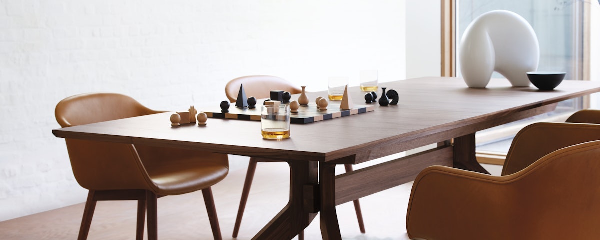 Man Ray Chess Set on Cross Extension Table in dining room setting