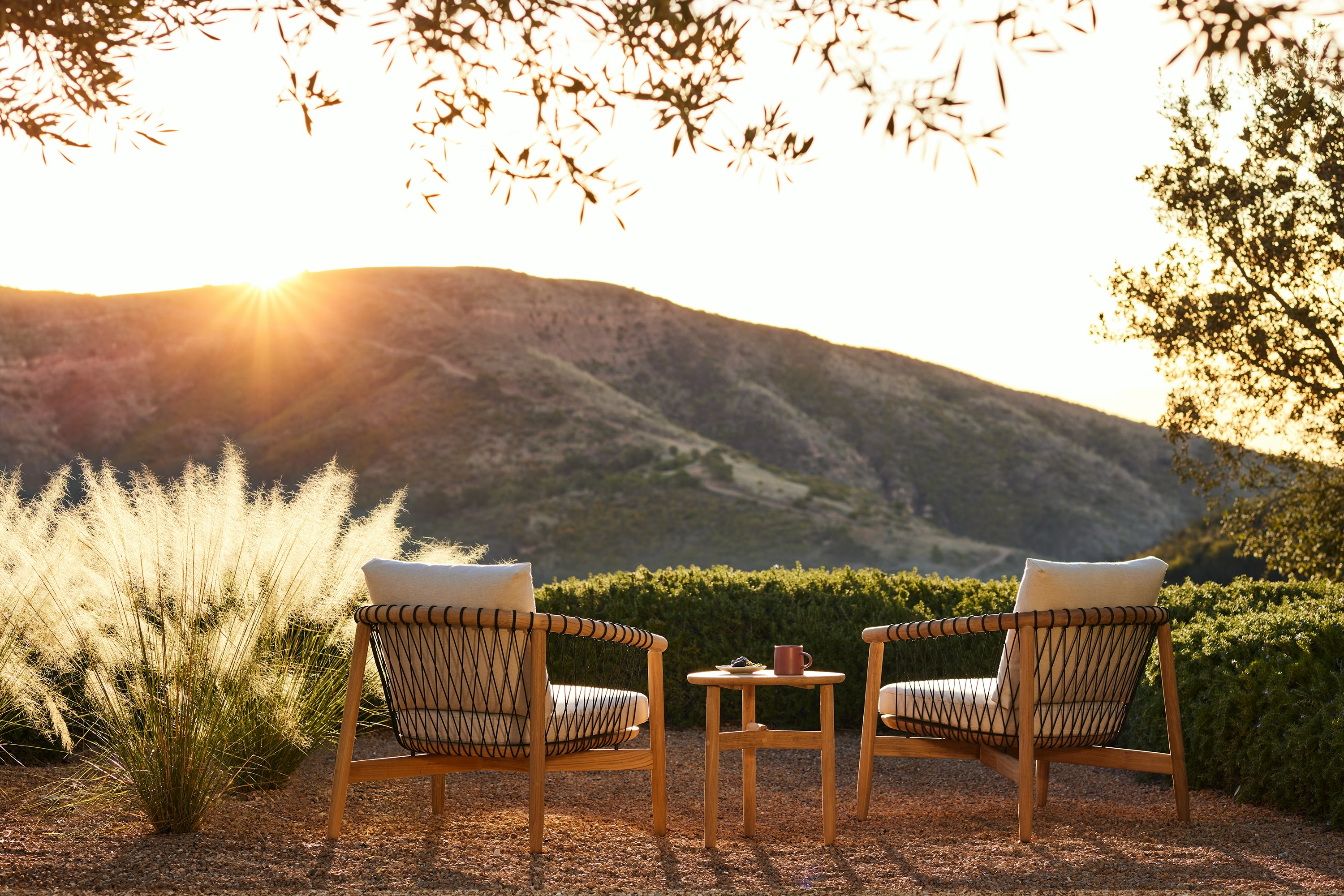 Crosshatch Outdoor Lounge Chairs and Trilobe Side Table in an environmental setting.
