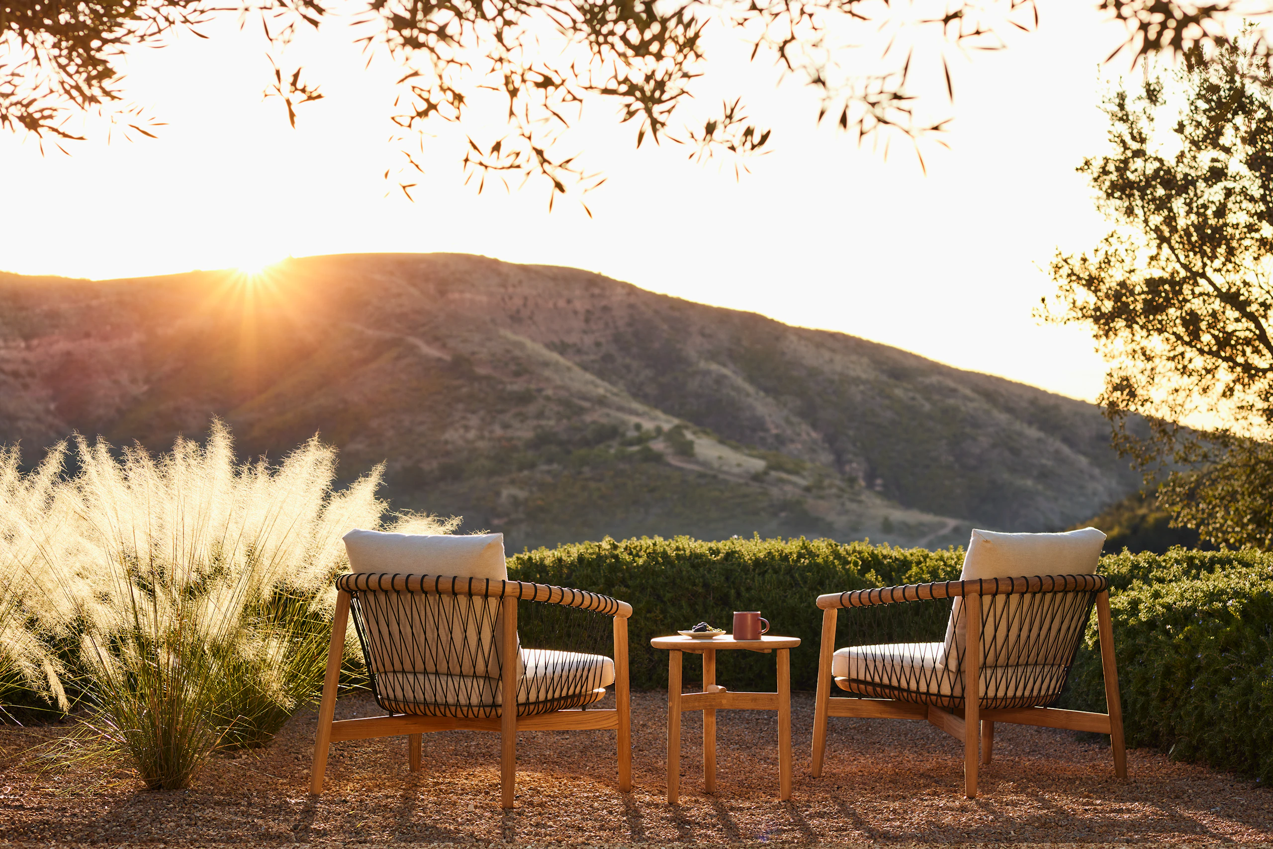 Crosshatch Outdoor Lounge Chairs and Trilobe Side Table in an environmental setting.