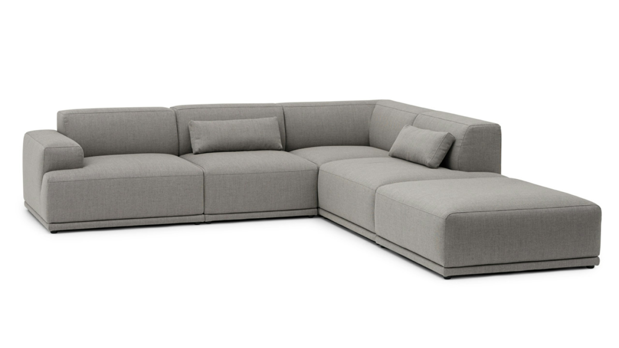 A three-quarter front view of a grey Connect Sofa by Muuto