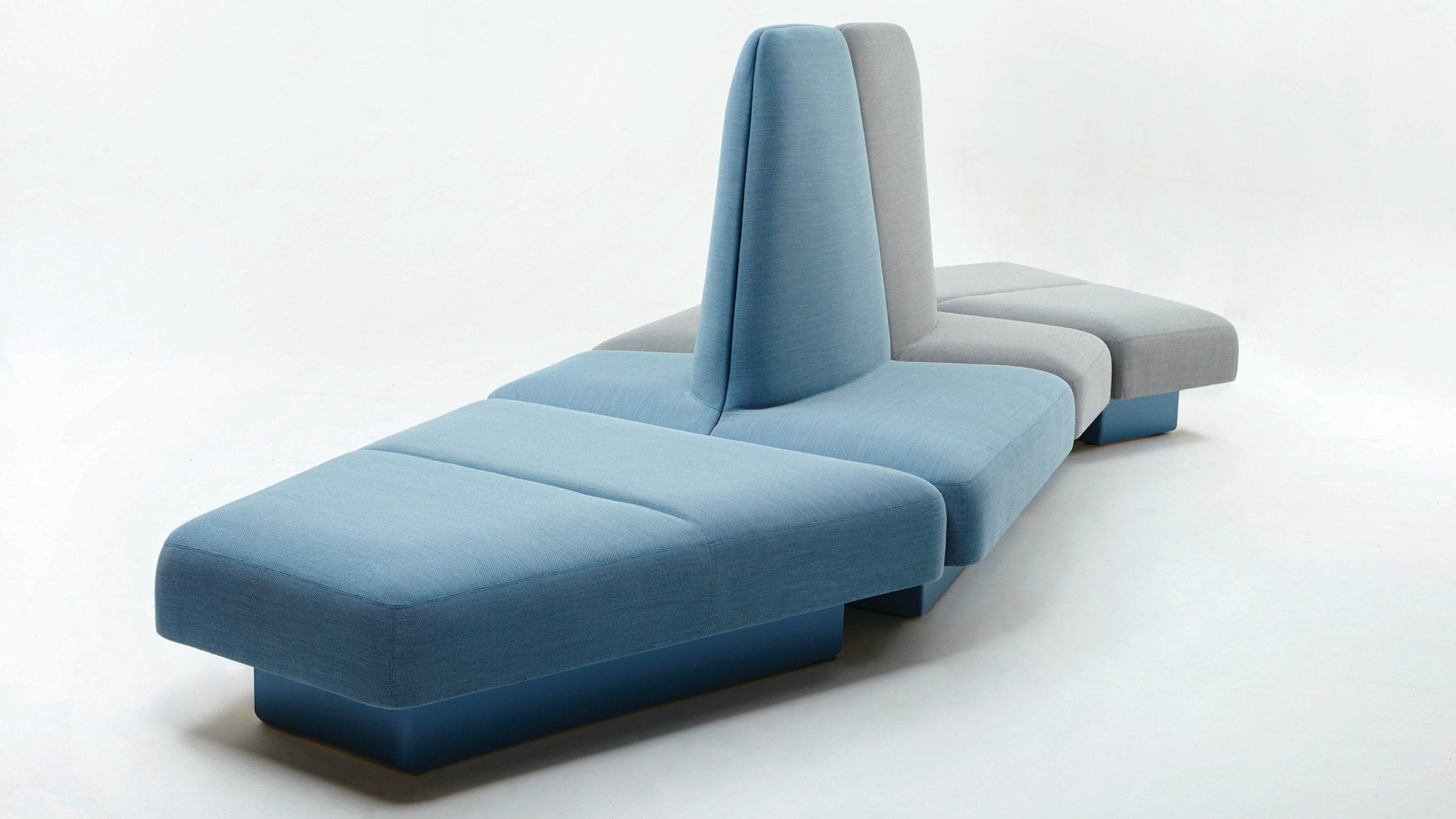 A NaughtOne Rhyme Modular Seating unit made of blue and gray pieces, viewed at an angle.