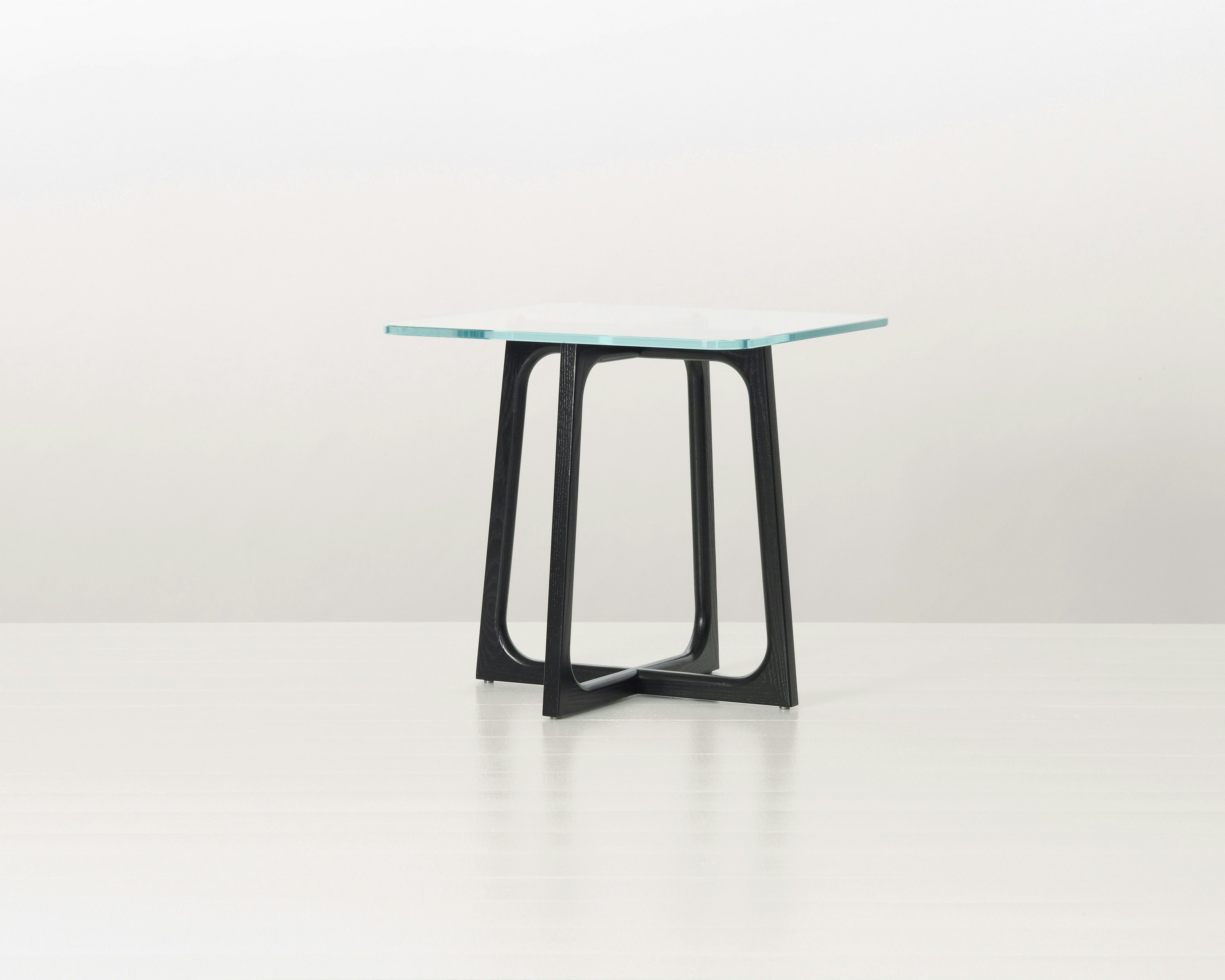 A square Loophole side table with a glass top and ebony-ash base.