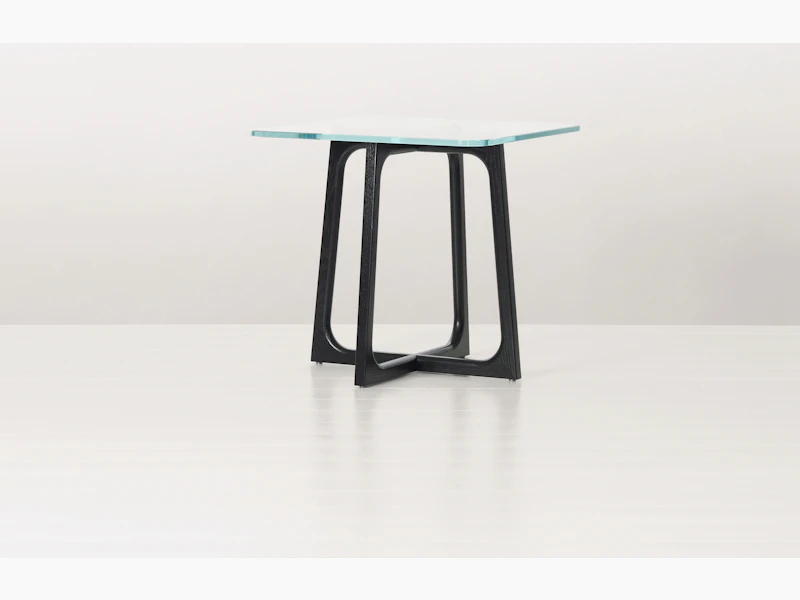 A square Loophole side table with a glass top and ebony-ash base.