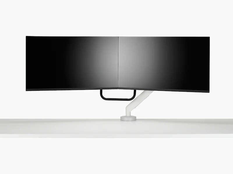 White dual Flo X monitor arm set up with 32'' screens, viewed from the front