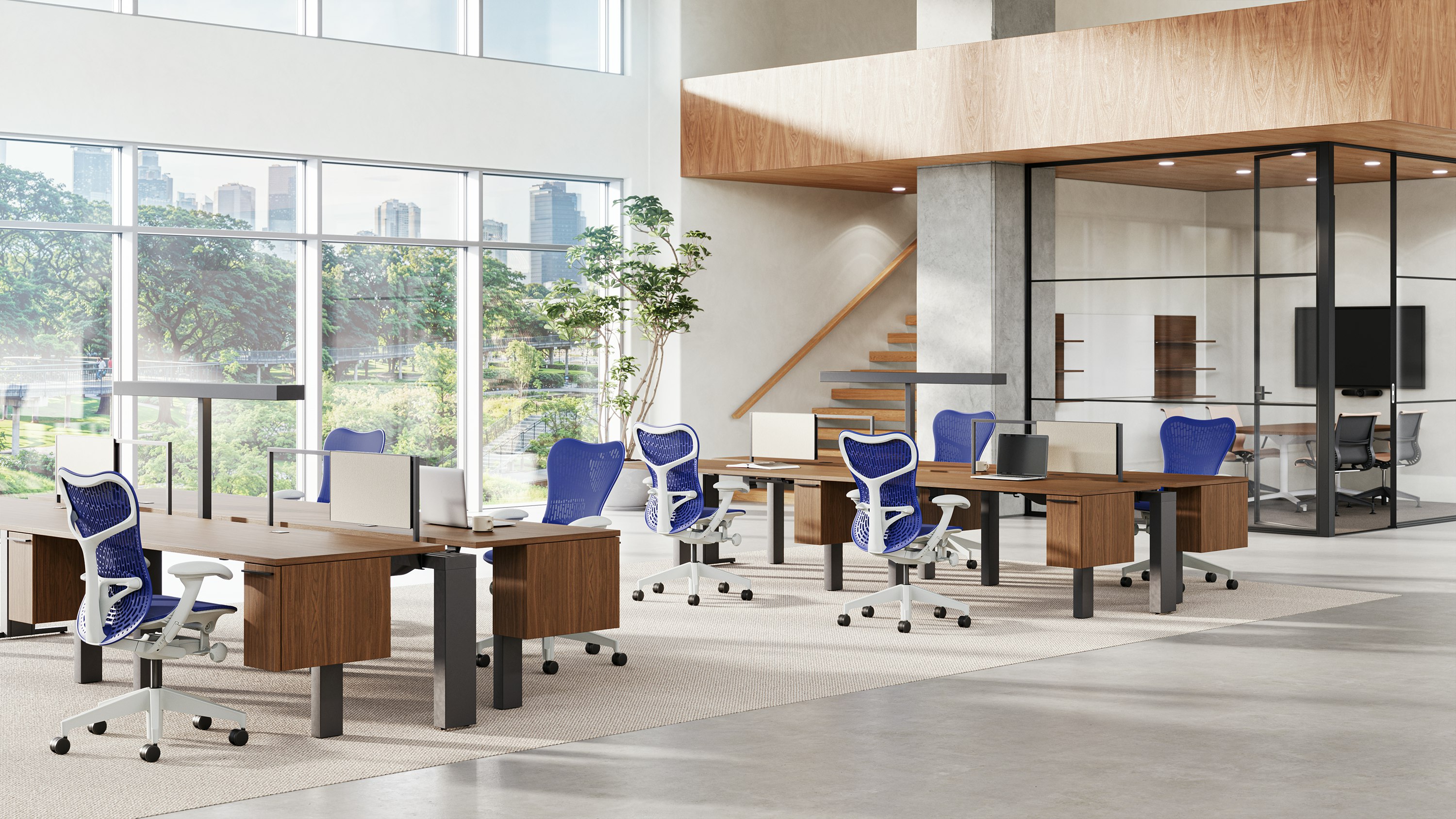 Two workstations each surrounded by four Mirra 2 chairs in ultramarine blue in a touchdown setting with offices in the background.