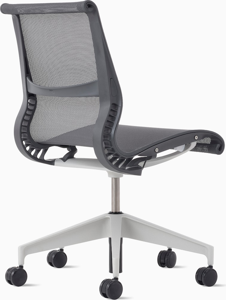 Rear angle view of a Setu chair without arms in grey.