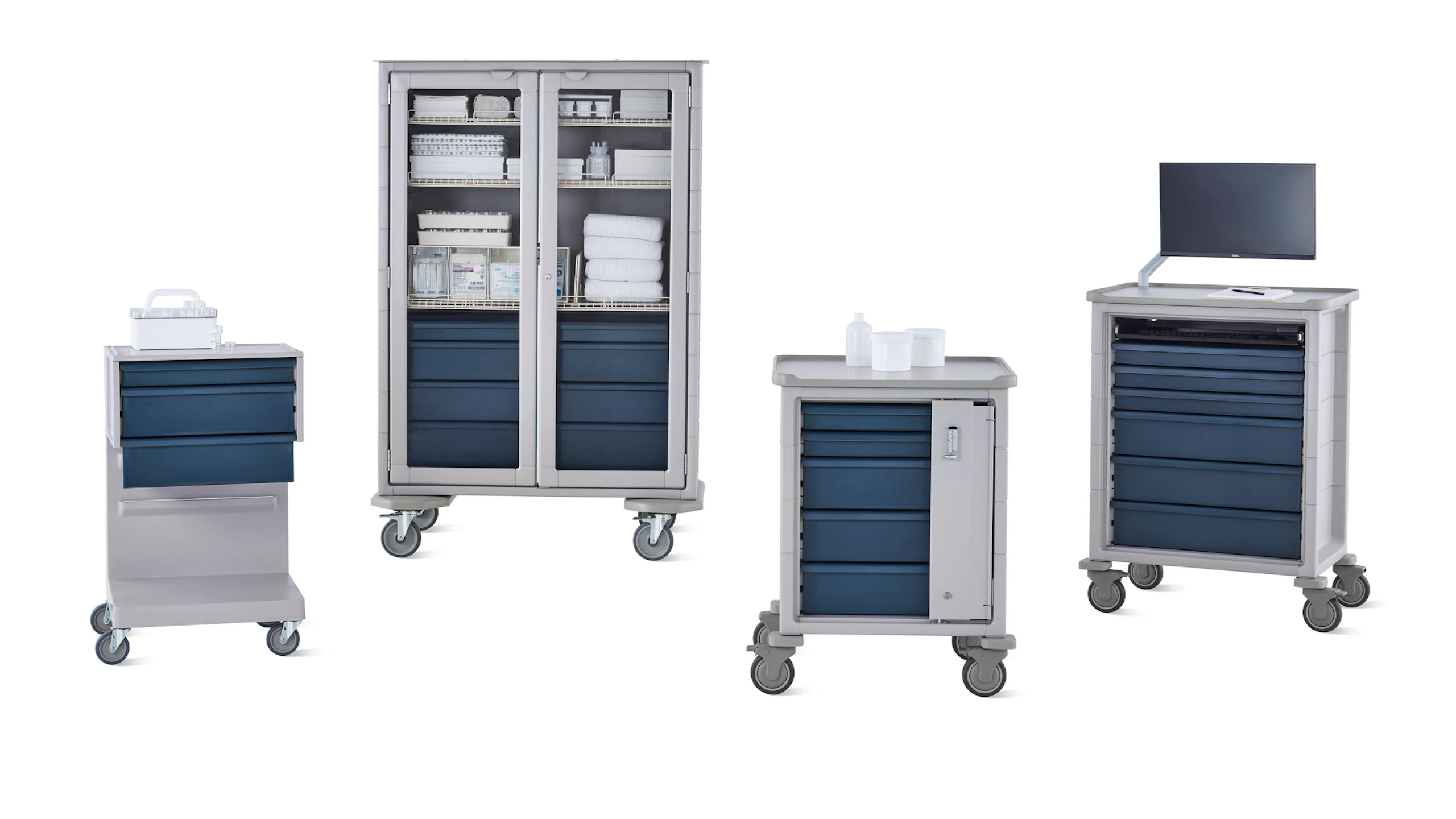 Group of Procedure and Supply Carts including L Cart, double-wide cart, supply cart, and technology cart in light gray body with dark gray drawers.