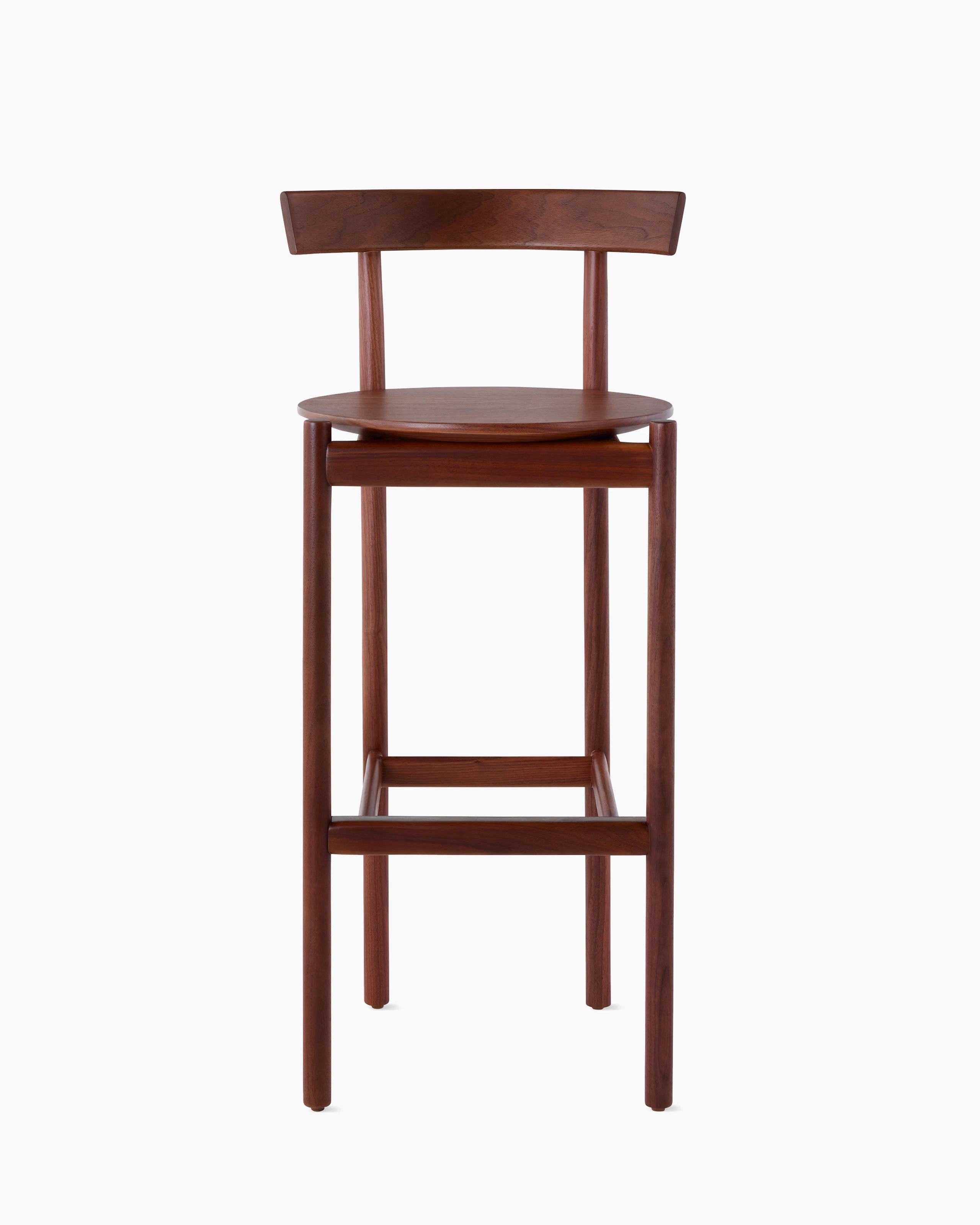 A walnut bar-height Comma Stool, viewed from the front.