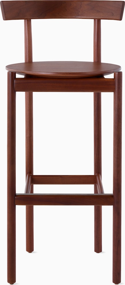 A walnut bar-height Comma Stool, viewed from the front.