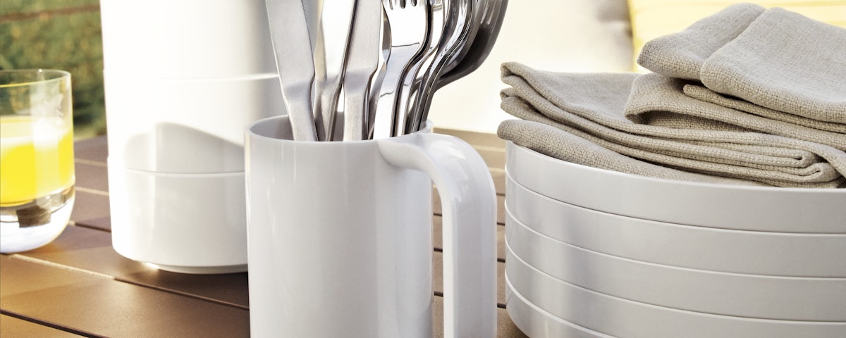 Closeup of Heller Dinnerware Set Bowls, Mug, and Plates on a cafe table