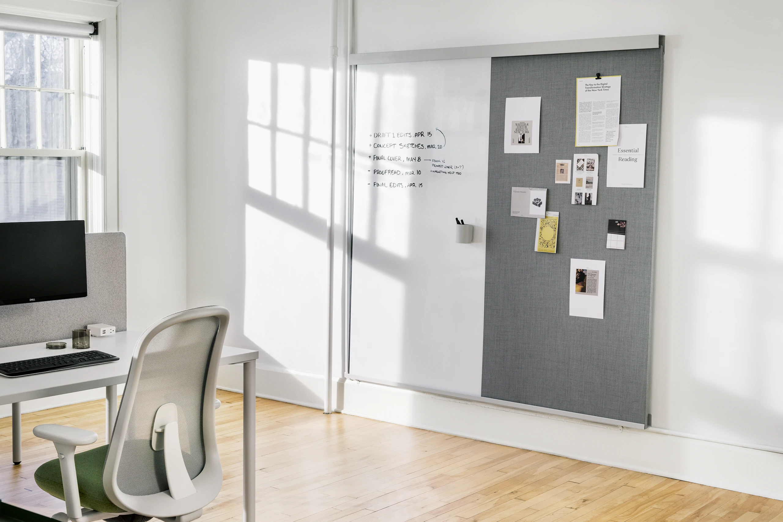 An OE1 Wall Rail and Board with a marker board and project board and an OE1 Rectangular Table and Lino Chair in the foreground.