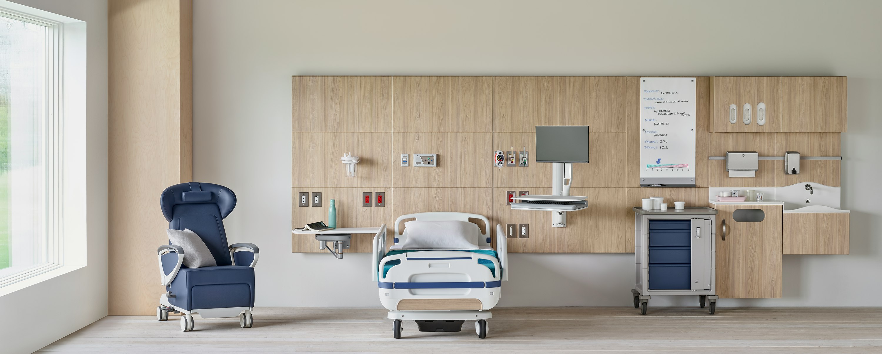 Compass System headwall in a patient room with a blue Ava Recliner with a Procedure and Supply Cart with MBrace technology support.