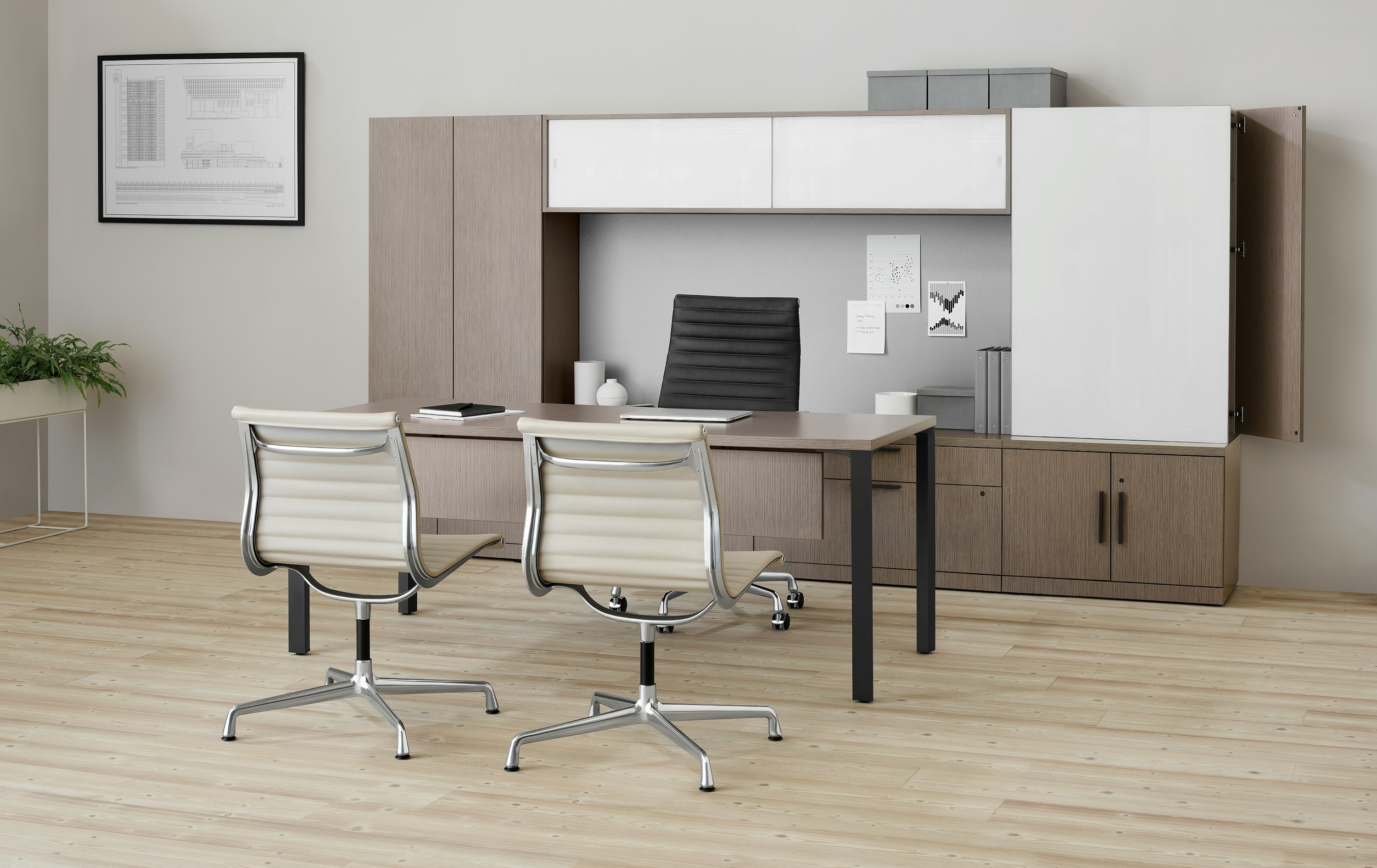 Dark wood Canvas Private Office with two tan Eames side chairs and a black executive chair.