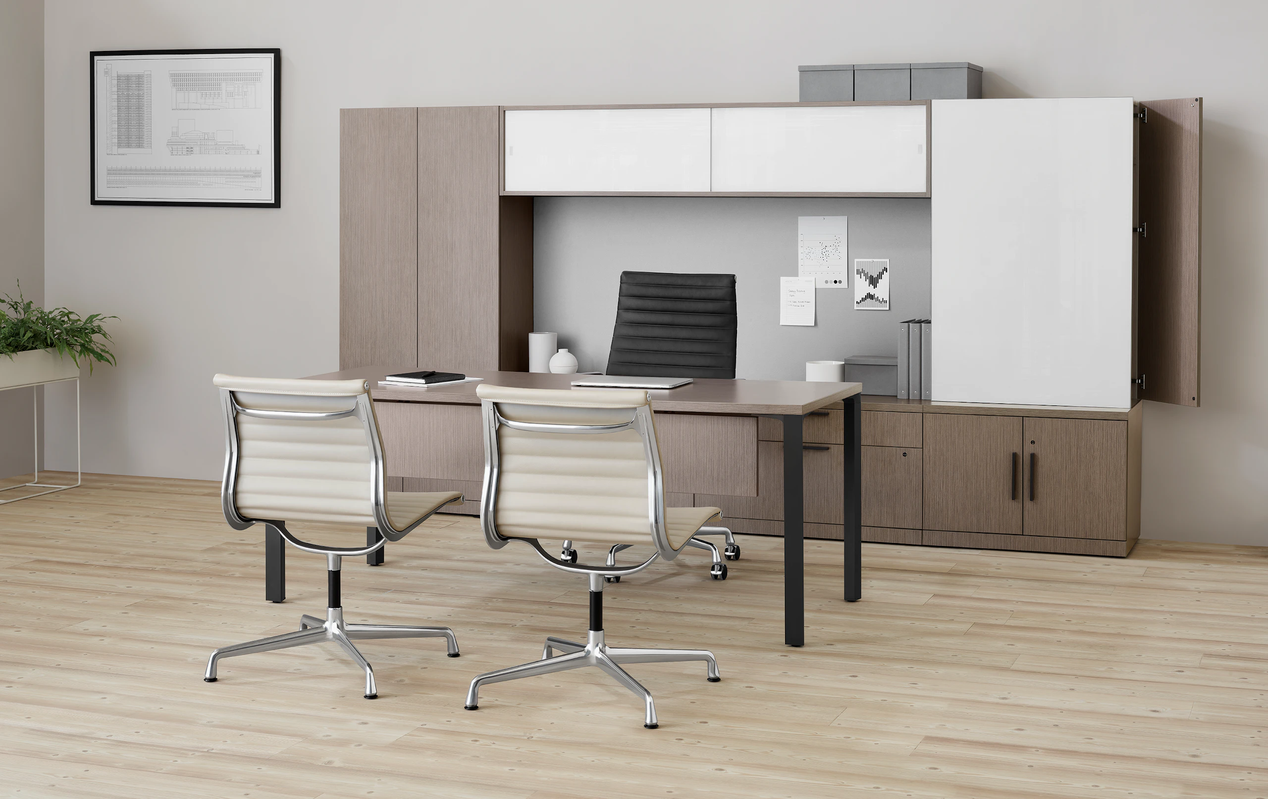 Dark wood Canvas Private Office with two tan Eames side chairs and a black executive chair.