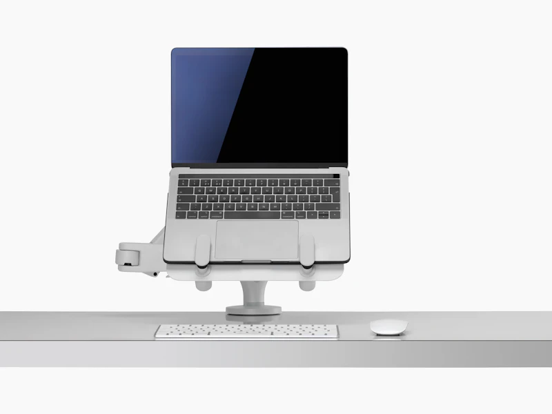Front view of an open laptop raised and supported by an Ollin Laptop and Tablet Mount connected to an Ollin Monitor Arm.
