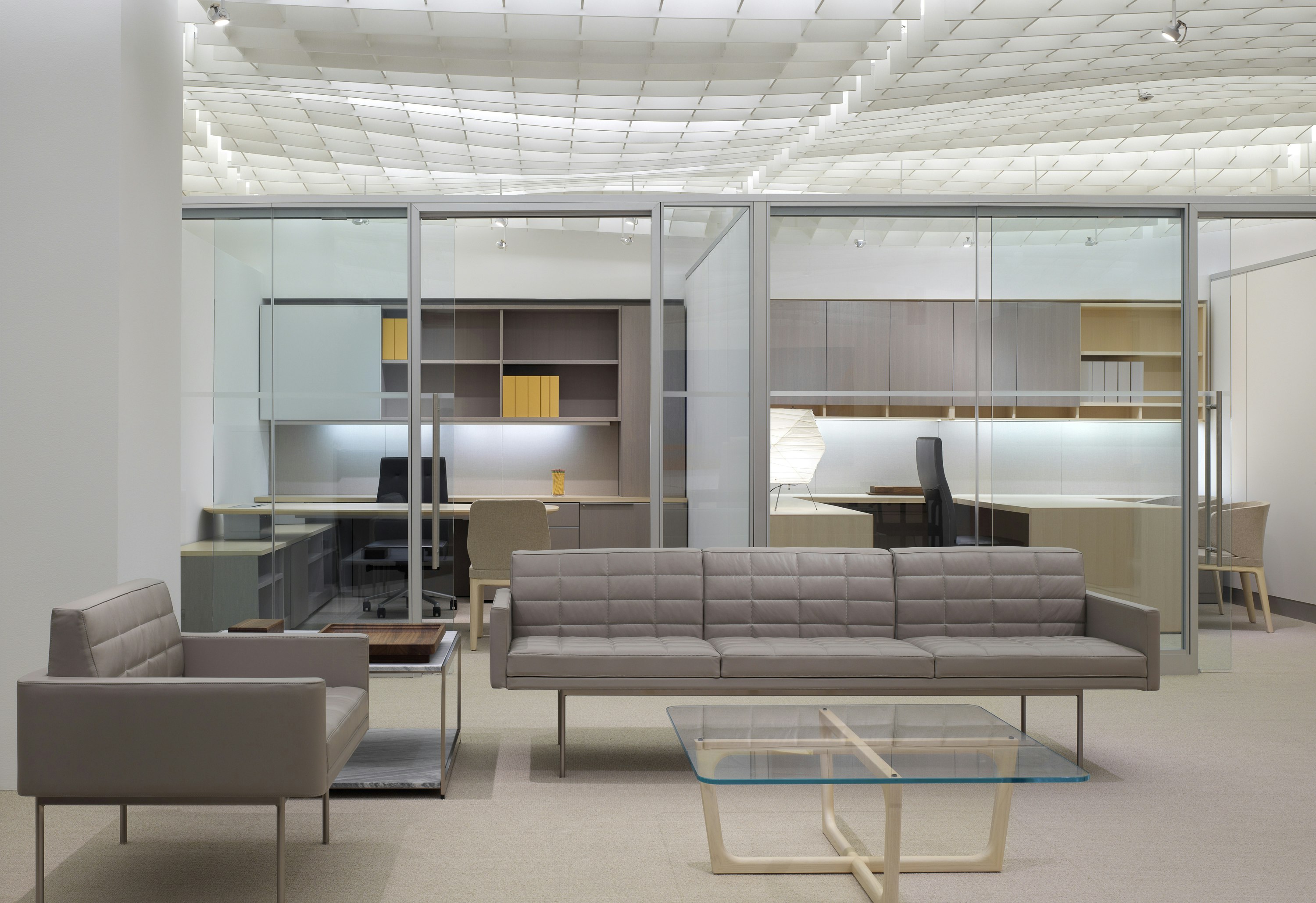 NeoCon 2011 Chicago Showroom Chairman Suite Lounge and Private Offices featuring tuxedo component lounge sofas and a loophole table.