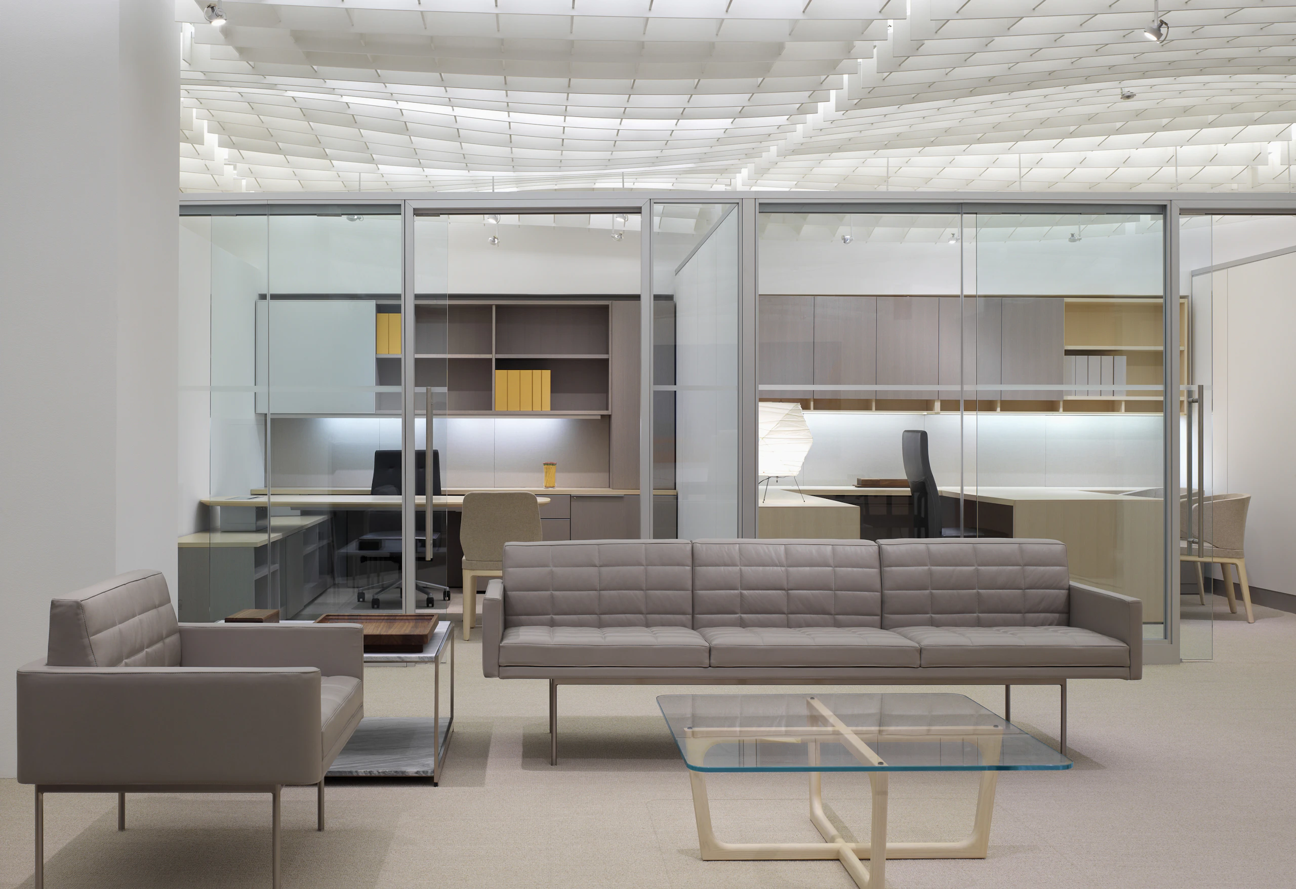 NeoCon 2011 Chicago Showroom Chairman Suite Lounge and Private Offices featuring tuxedo component lounge sofas and a loophole table.