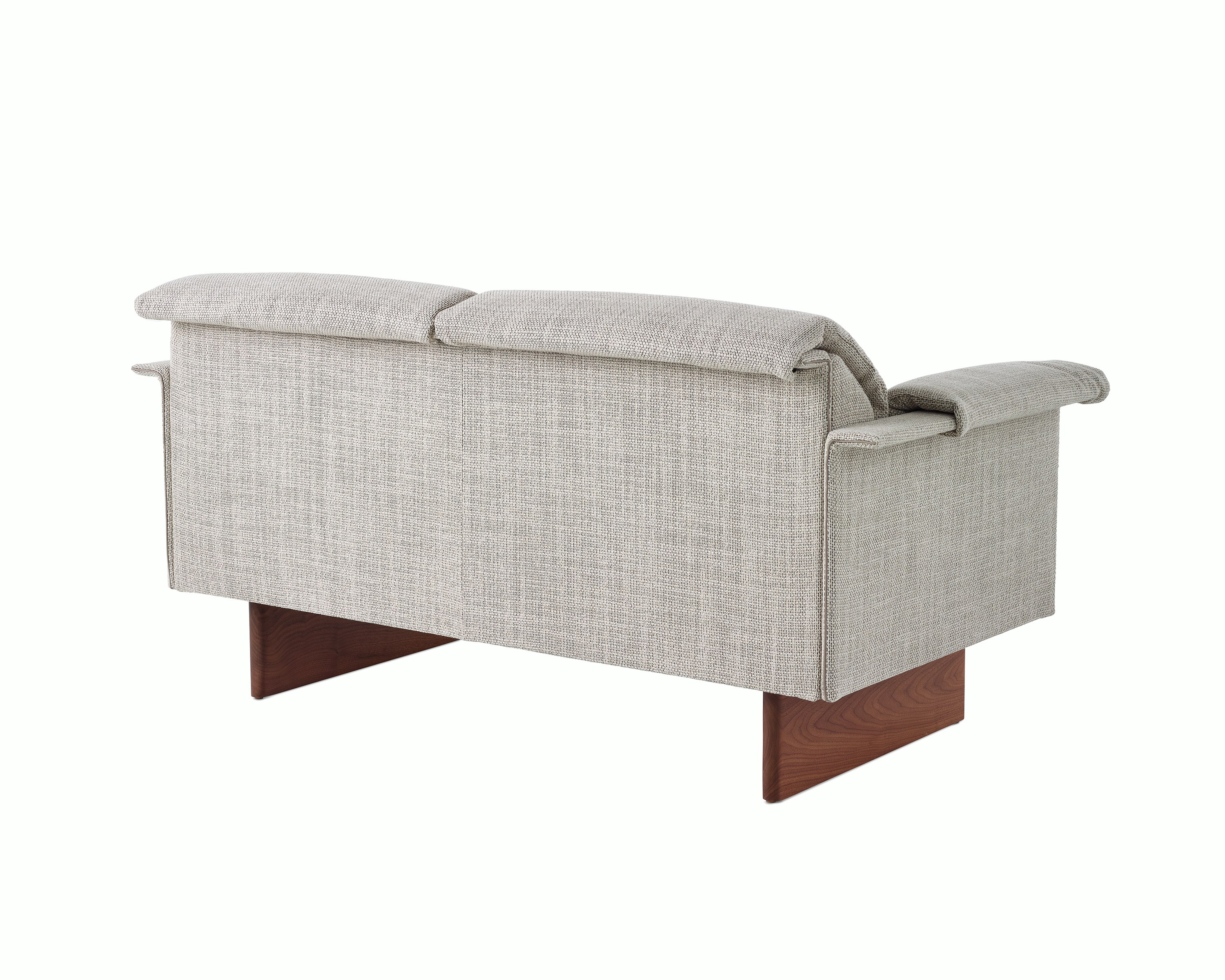 Mantle Two Seater Sofa in Capri Stone with Walnut Wood Base, viewed at an angle.