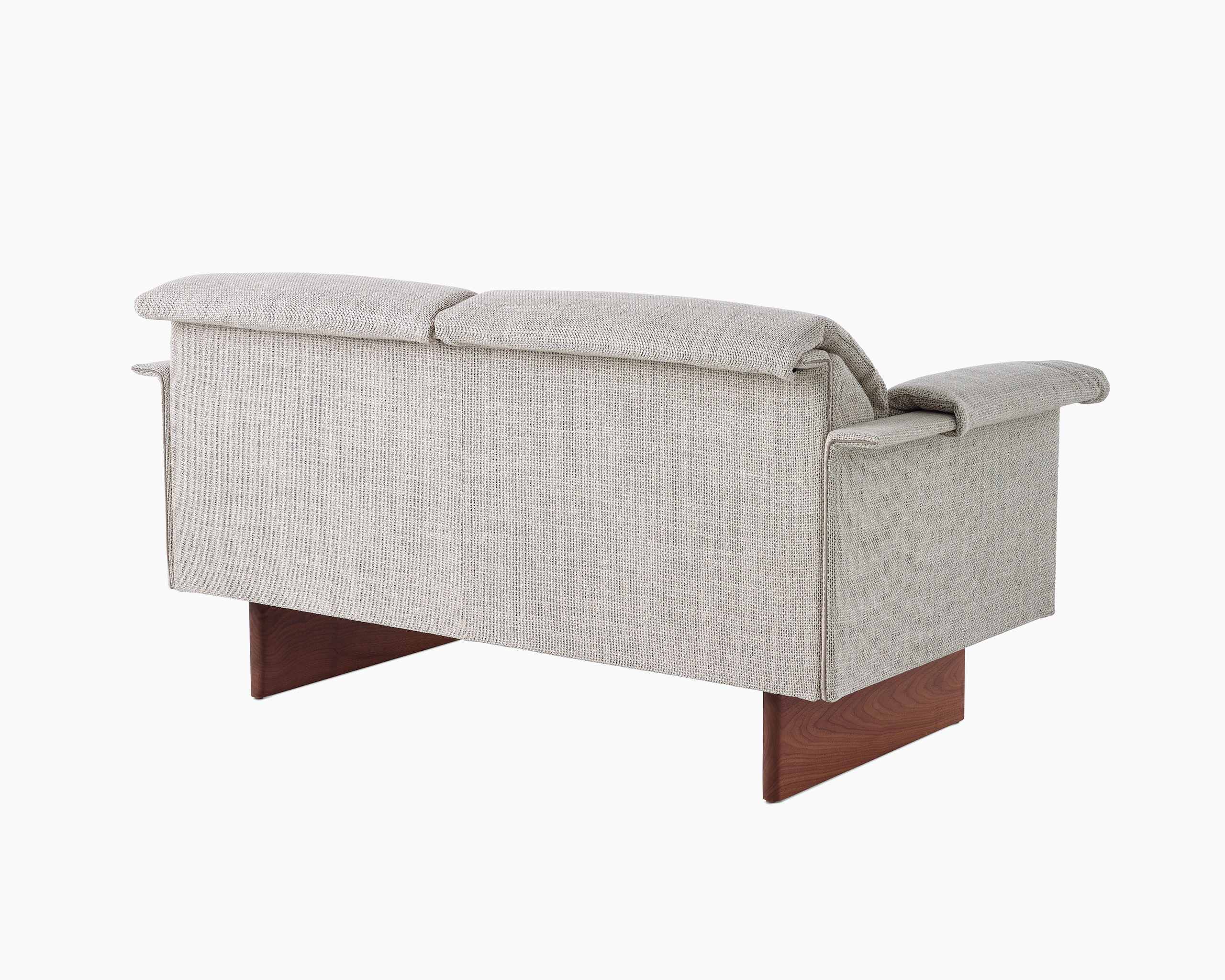 Mantle Two Seater Sofa in Capri Stone with Walnut Wood Base, viewed at an angle.