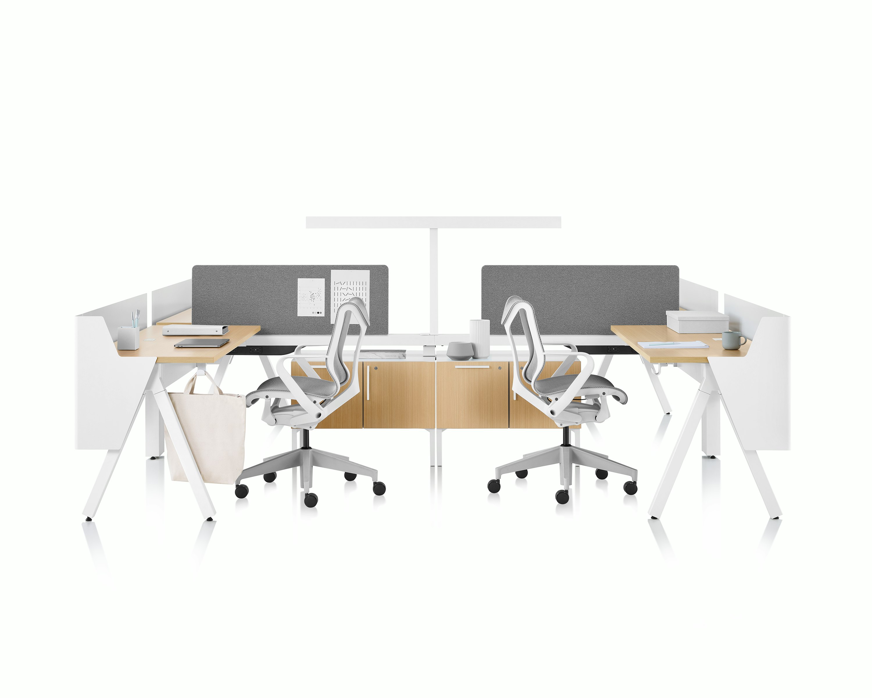 Brown and white Canvas Vista workstations with a-shaped legs, modesty and privacy screens, t-shaped light, gray boundary screens, and Cosm chairs.