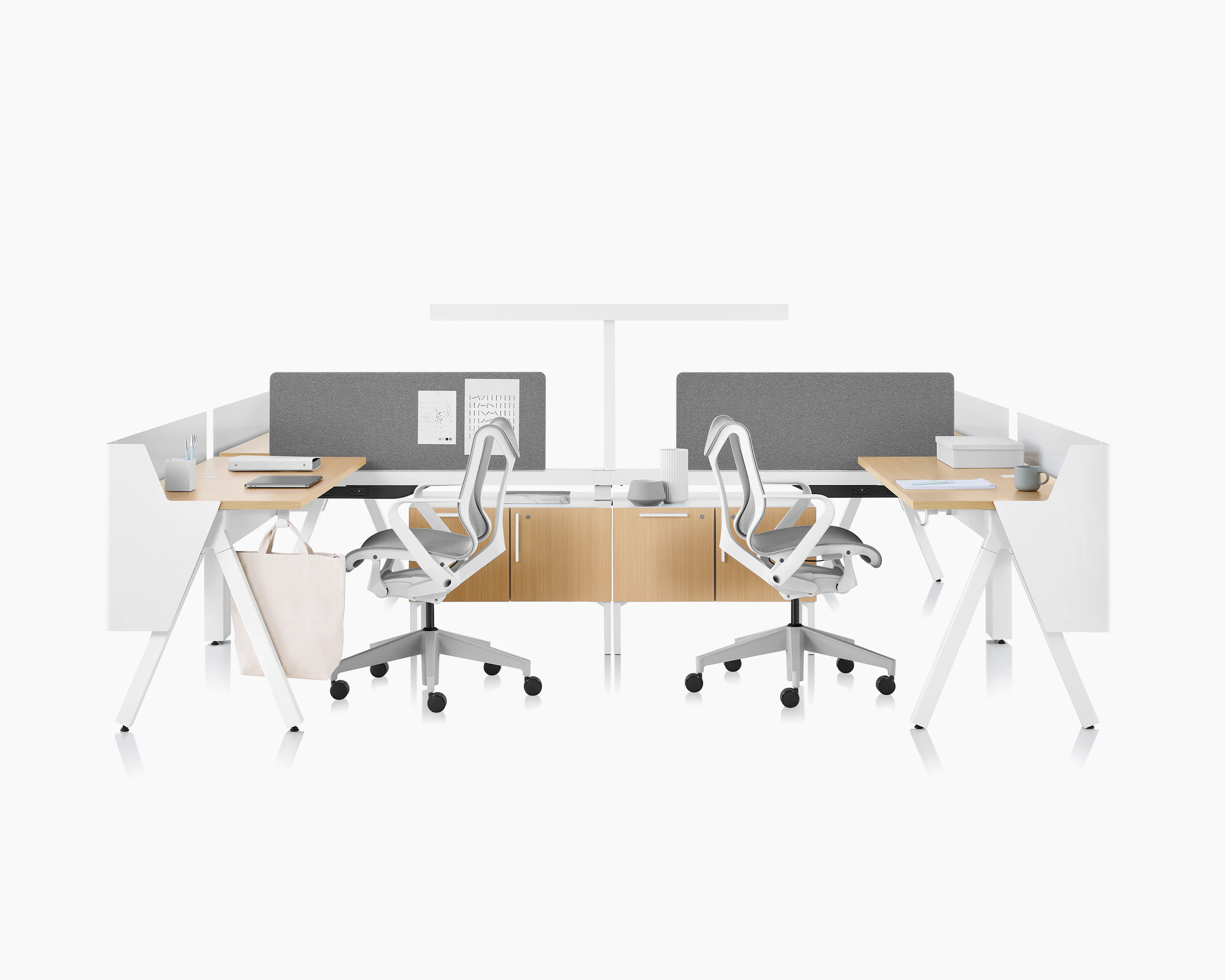 Brown and white Canvas Vista workstations with a-shaped legs, modesty and privacy screens, t-shaped light, gray boundary screens, and Cosm chairs.