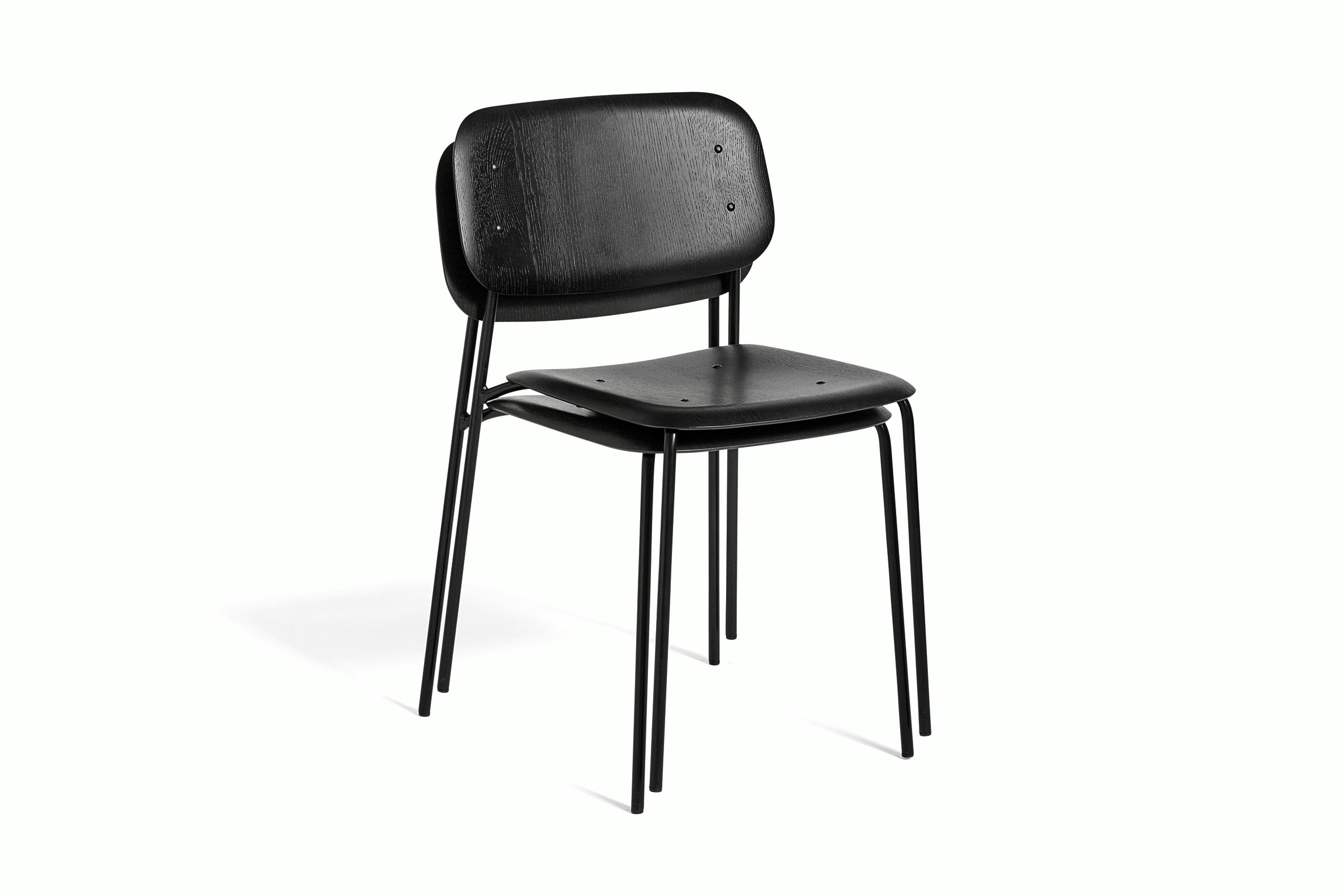Two black Soft Edge Chairs, stacked, viewed from the side.