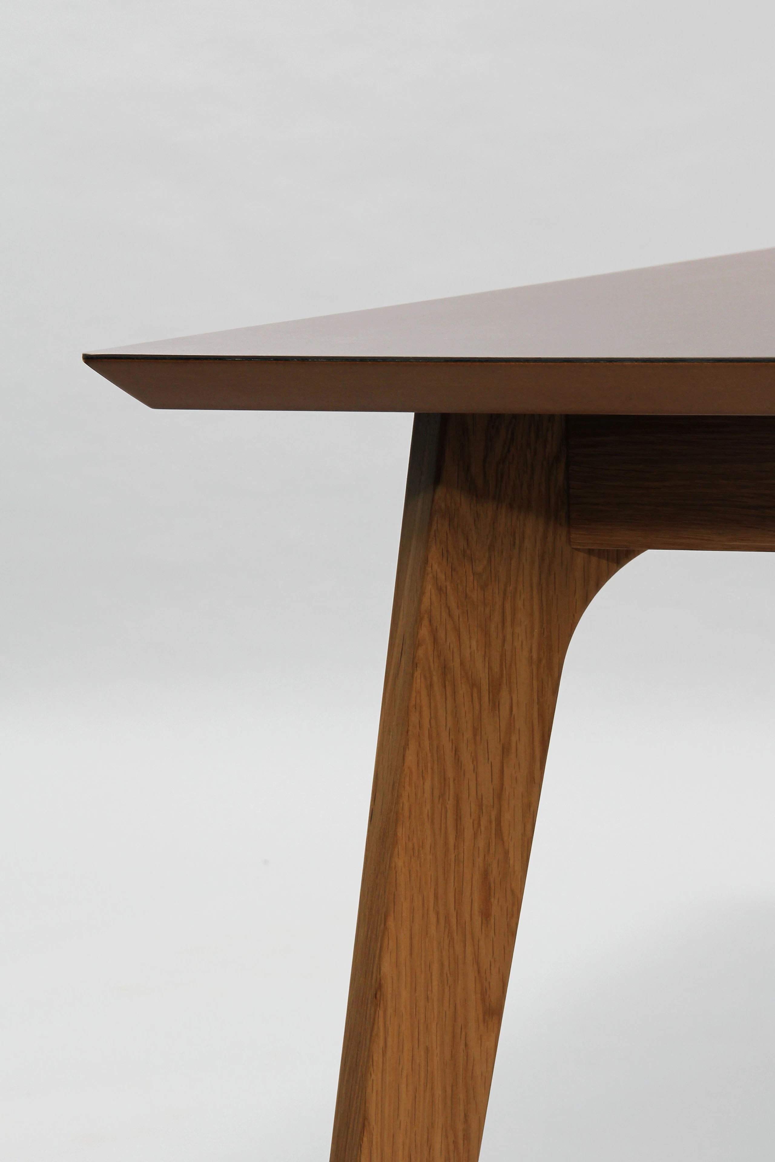 A close-up detail view of the polished MDF edge and reverse chamfer of a naughtone Dalby Conference Table.