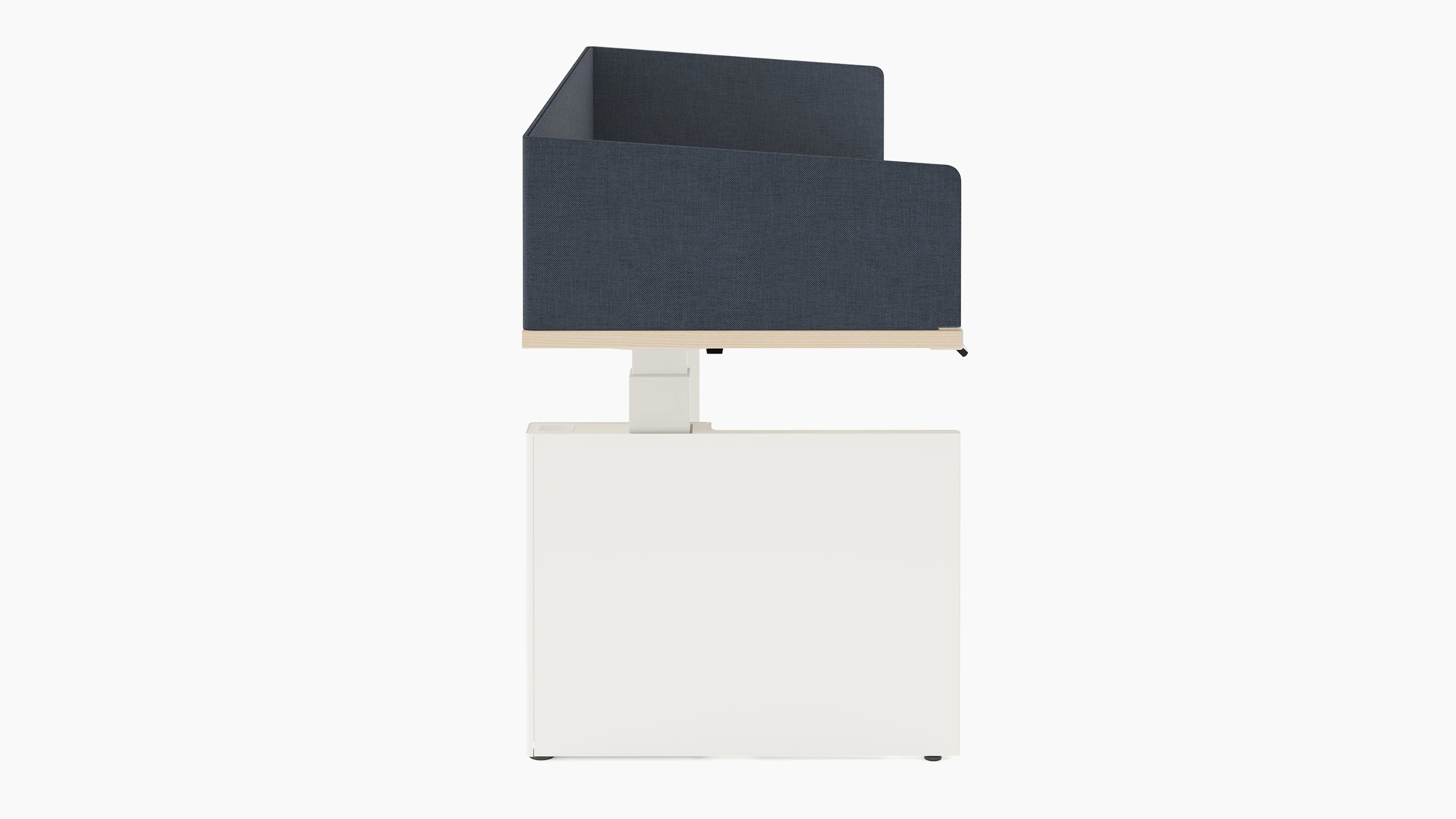 Height adjustable desk with white table shroud hiding underneath the table, and navy fabric privacy screen hiding the worksurface.